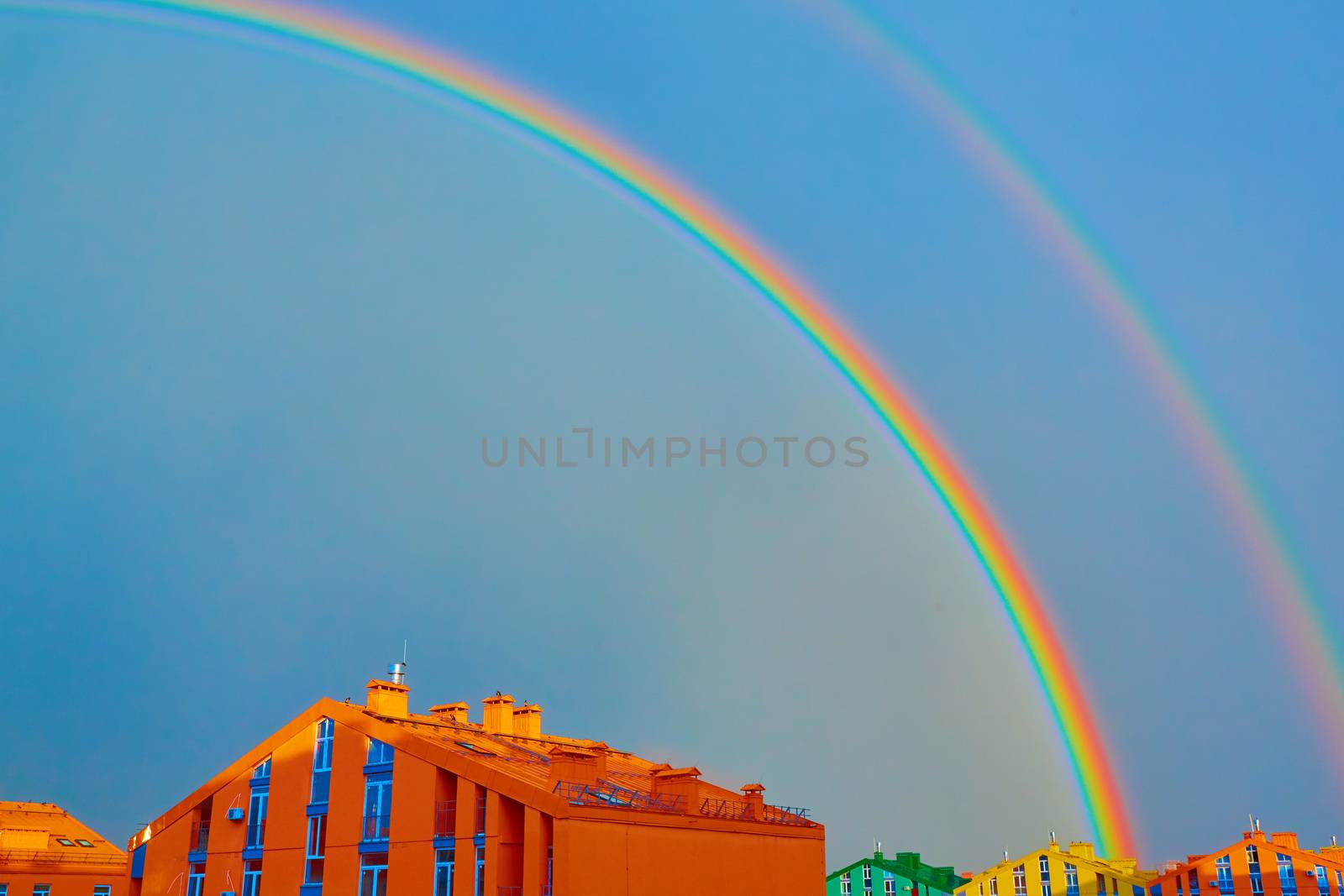 Double rainbow over bright colored houses. Kiev city