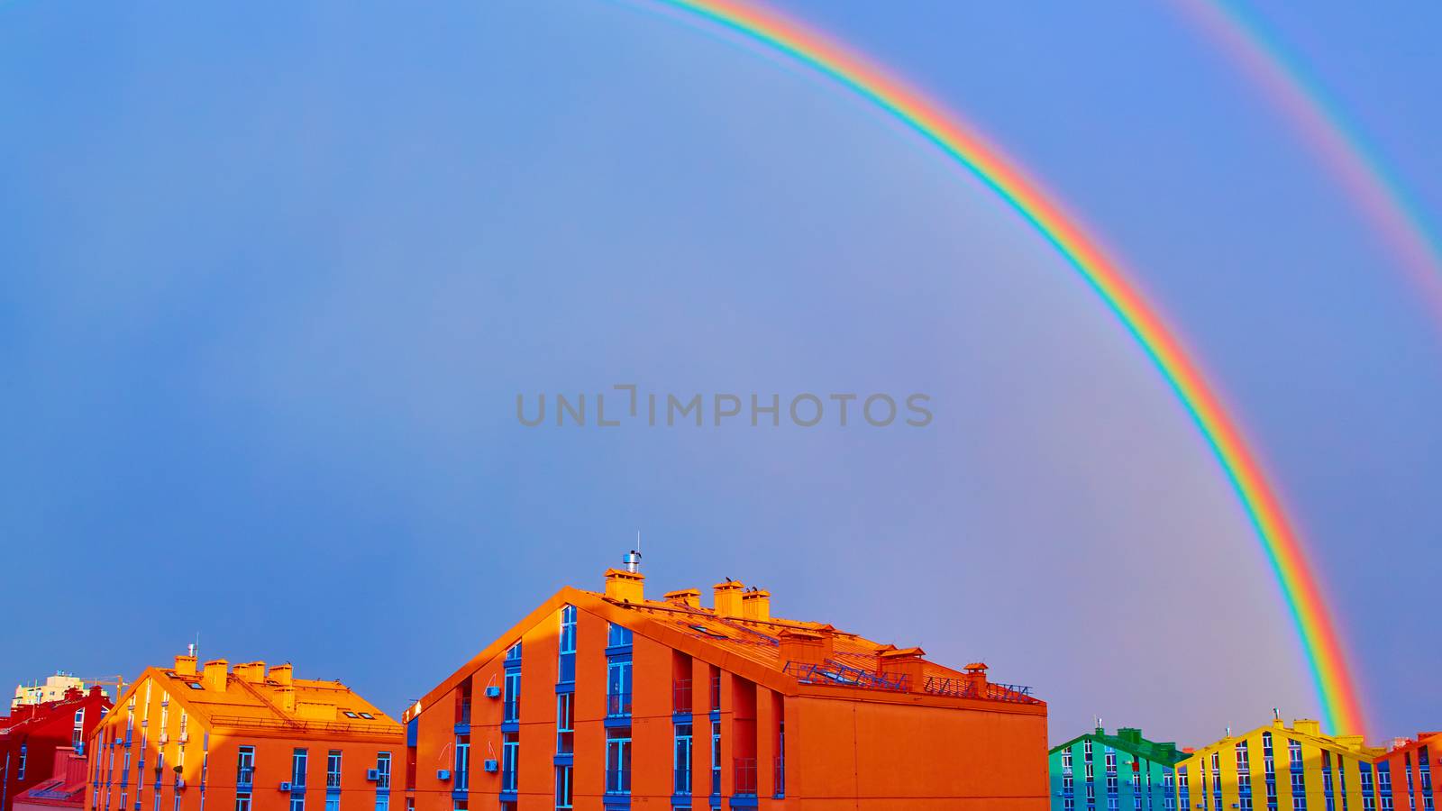 Double rainbow over bright colored houses. Kiev city