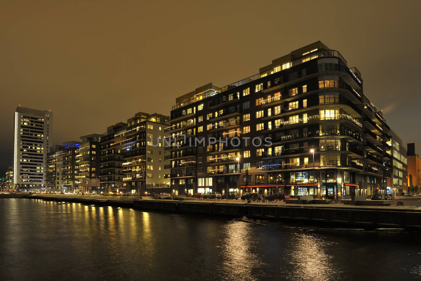 Modern apartment buildings in Stockholm neighborhood at night.
