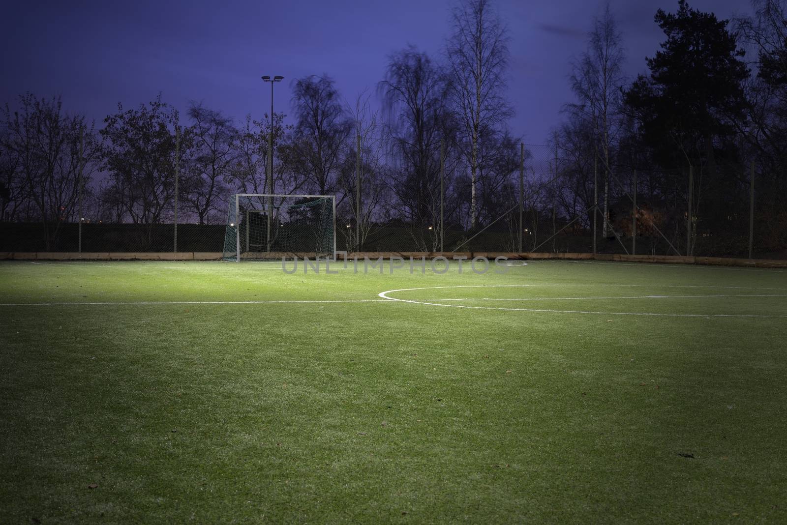 Empty soccer field at night.