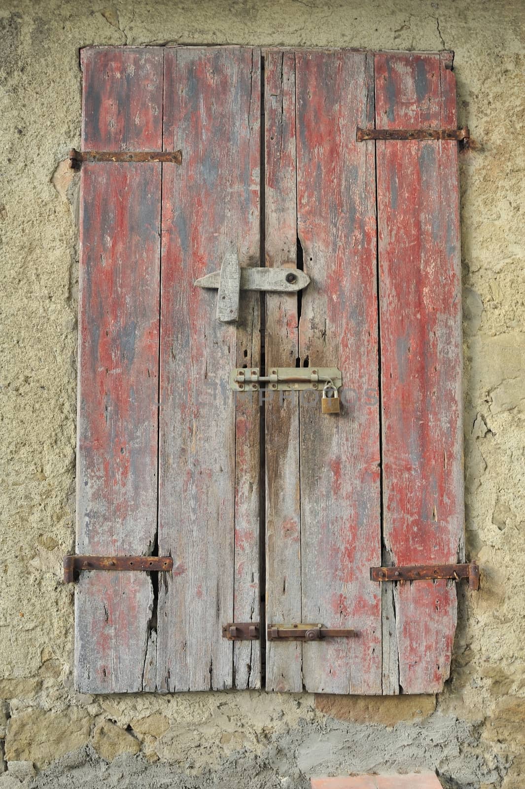 Rustic closed window with shutters.