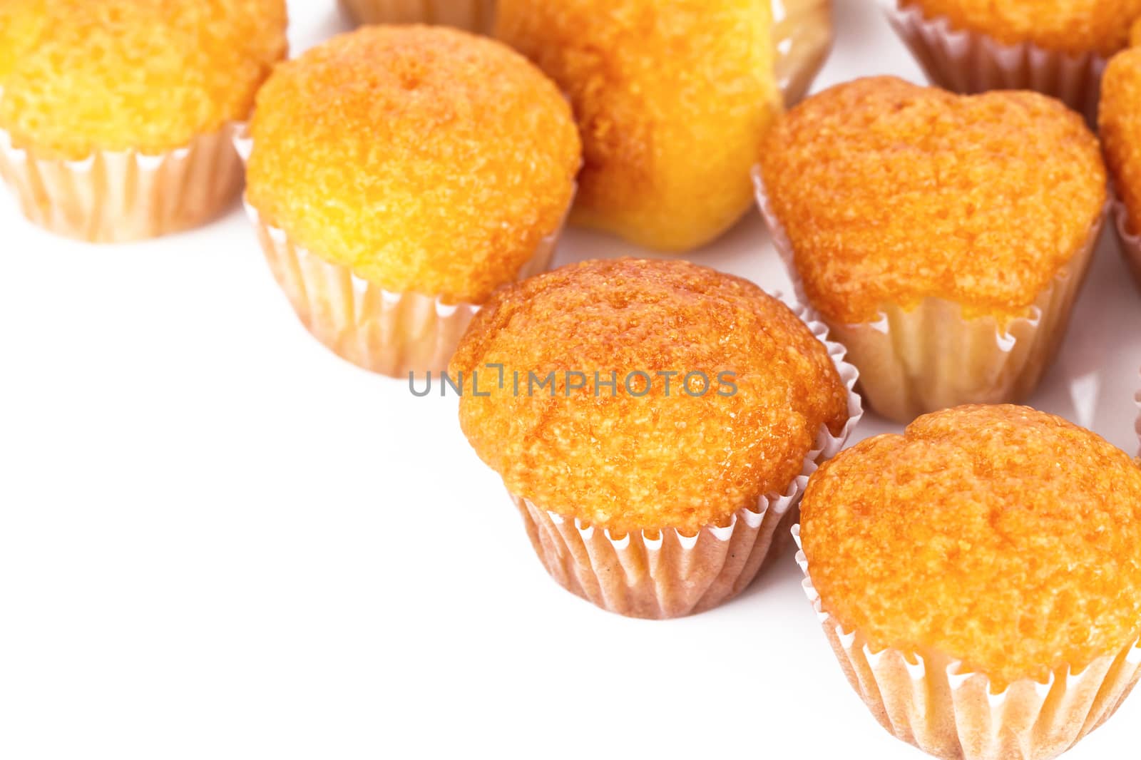 Delicious mini muffins on a white background by supersaiyan