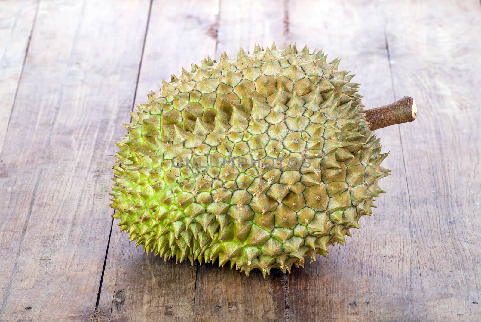 fresh green Durian on wooden plate by supersaiyan