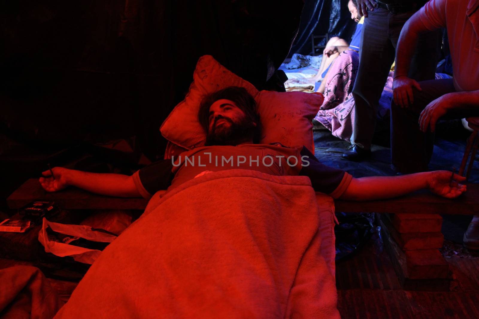 PARAGUAY, Greater Asuncion: 23 bus drivers from the firm Line 49, including one woman, lie crucified in front of the Labor, Employment and Social Security Ministry in Asuncion, on September 14, 2015. 	It has been 76 days since they started to protest after being dismissed by the company. More and more of the protesters have turned to crucifixion during this period to raise awareness of their cause. Some of them have also sewn their lips together on hunger strike. 