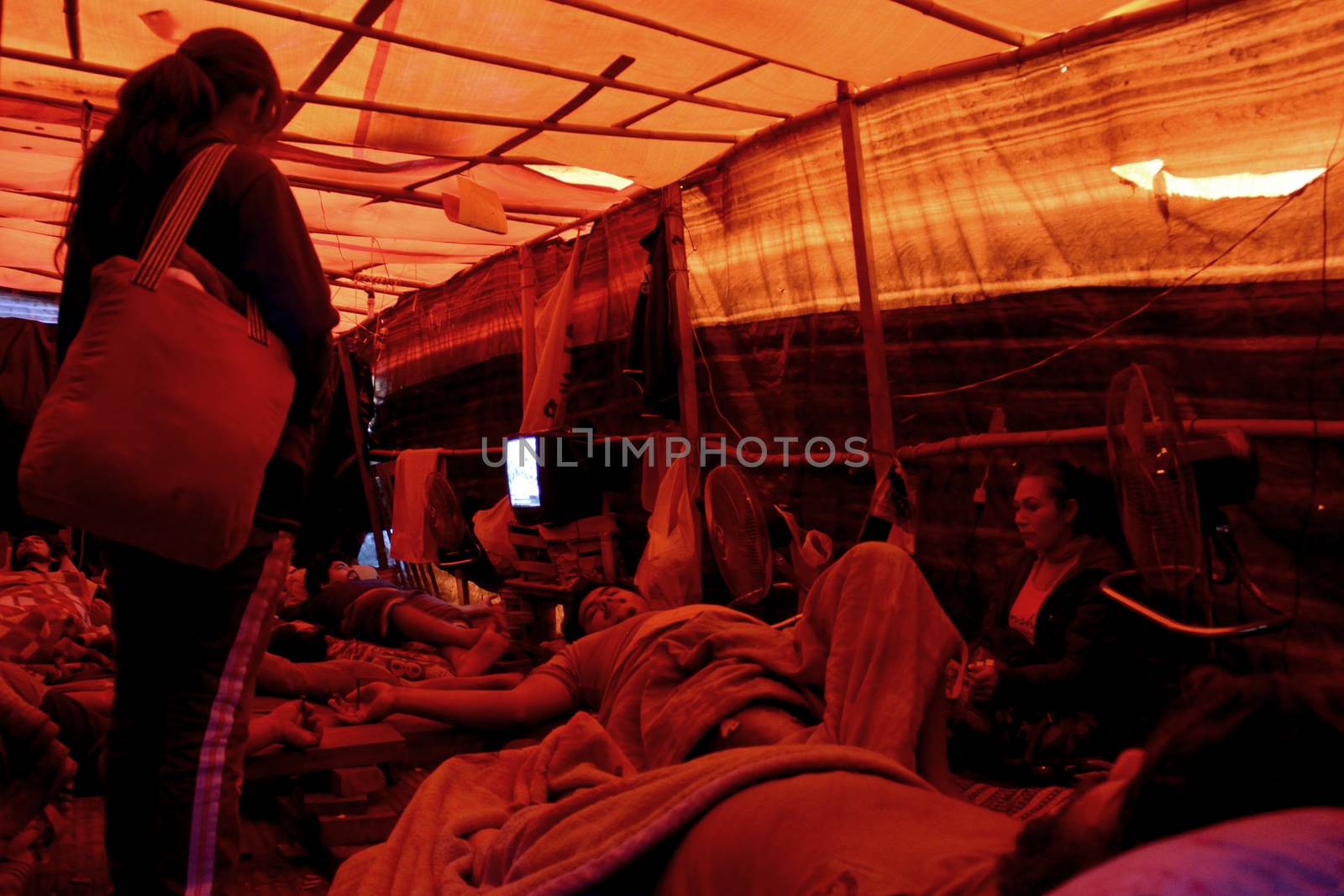 PARAGUAY, Greater Asuncion: 23 bus drivers from the firm Line 49, including one woman, lie crucified in front of the Labor, Employment and Social Security Ministry in Asuncion, on September 14, 2015. 	It has been 76 days since they started to protest after being dismissed by the company. More and more of the protesters have turned to crucifixion during this period to raise awareness of their cause. Some of them have also sewn their lips together on hunger strike. 