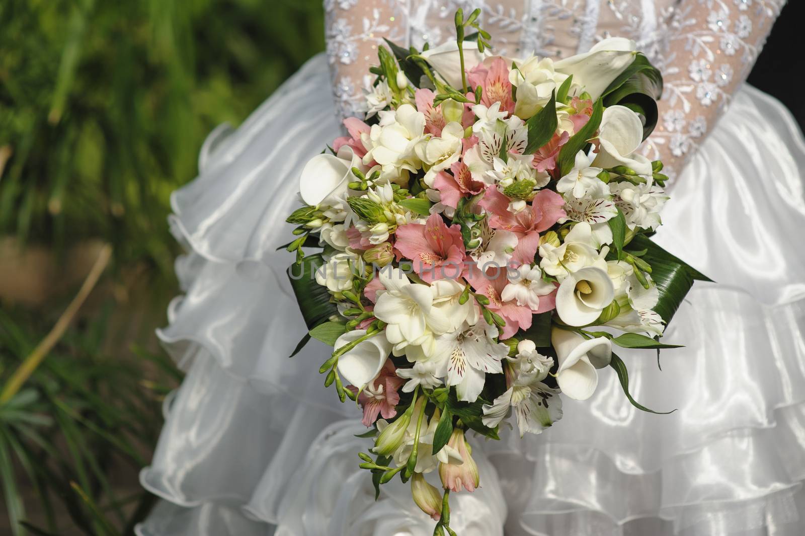 Bride holding white wedding bouquet by timonko
