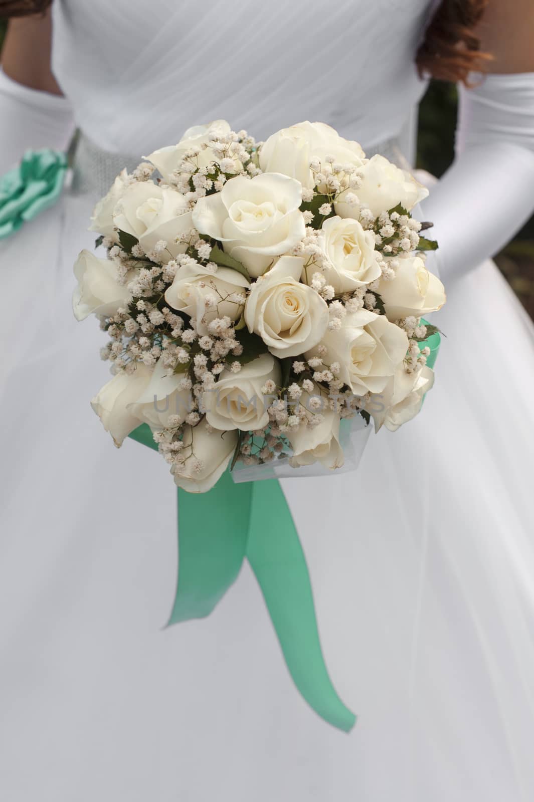 white rose bouquet in bride's hands