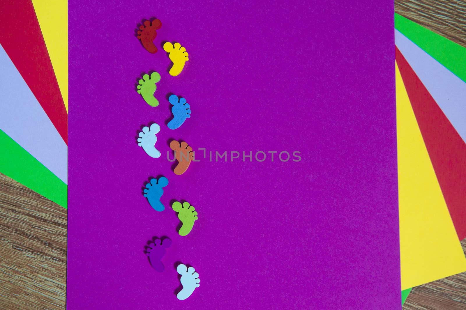 colored sheets of paper, handmade with footprints