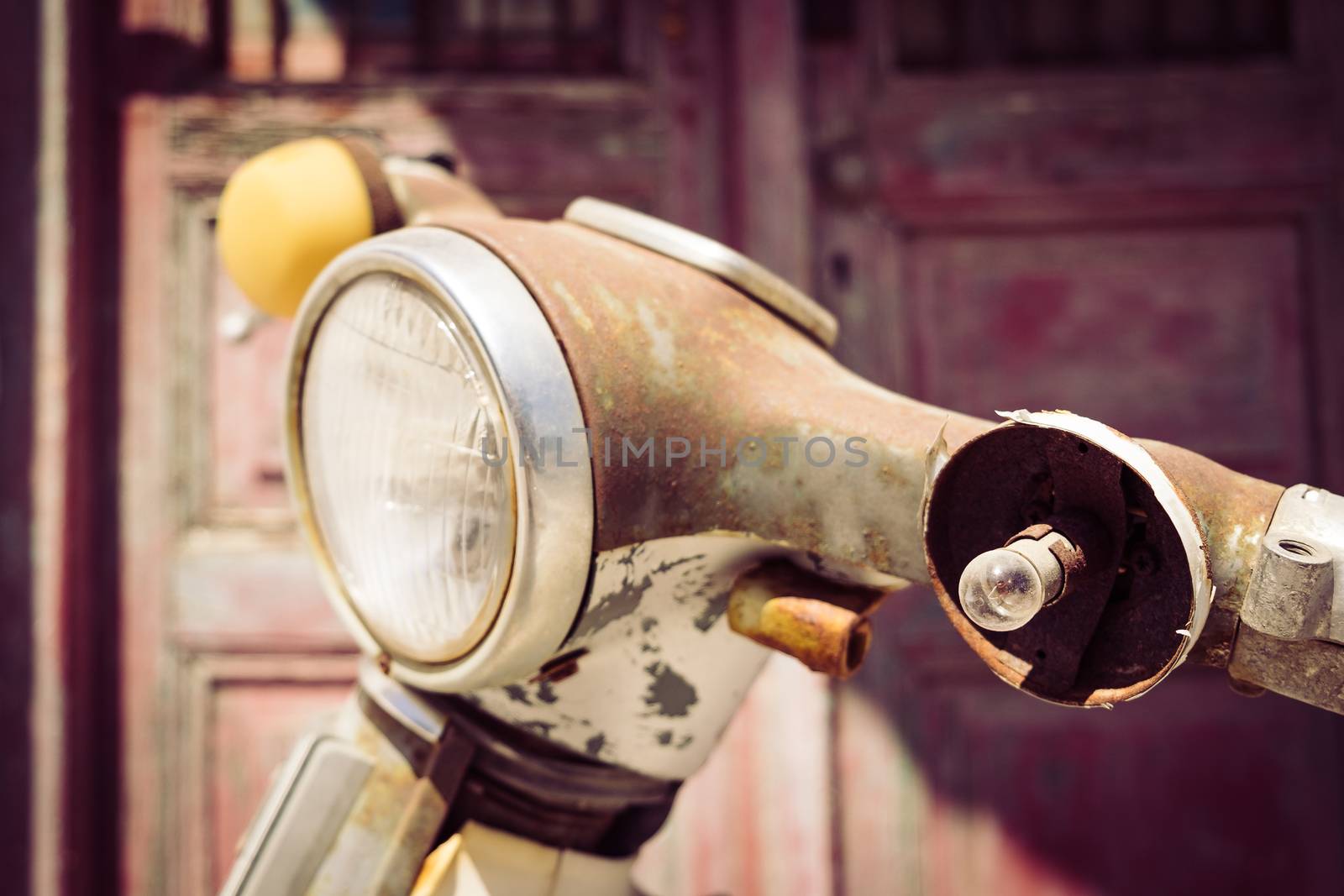 Detail of vintage motorcycle with borken light in filtered style by martinm303