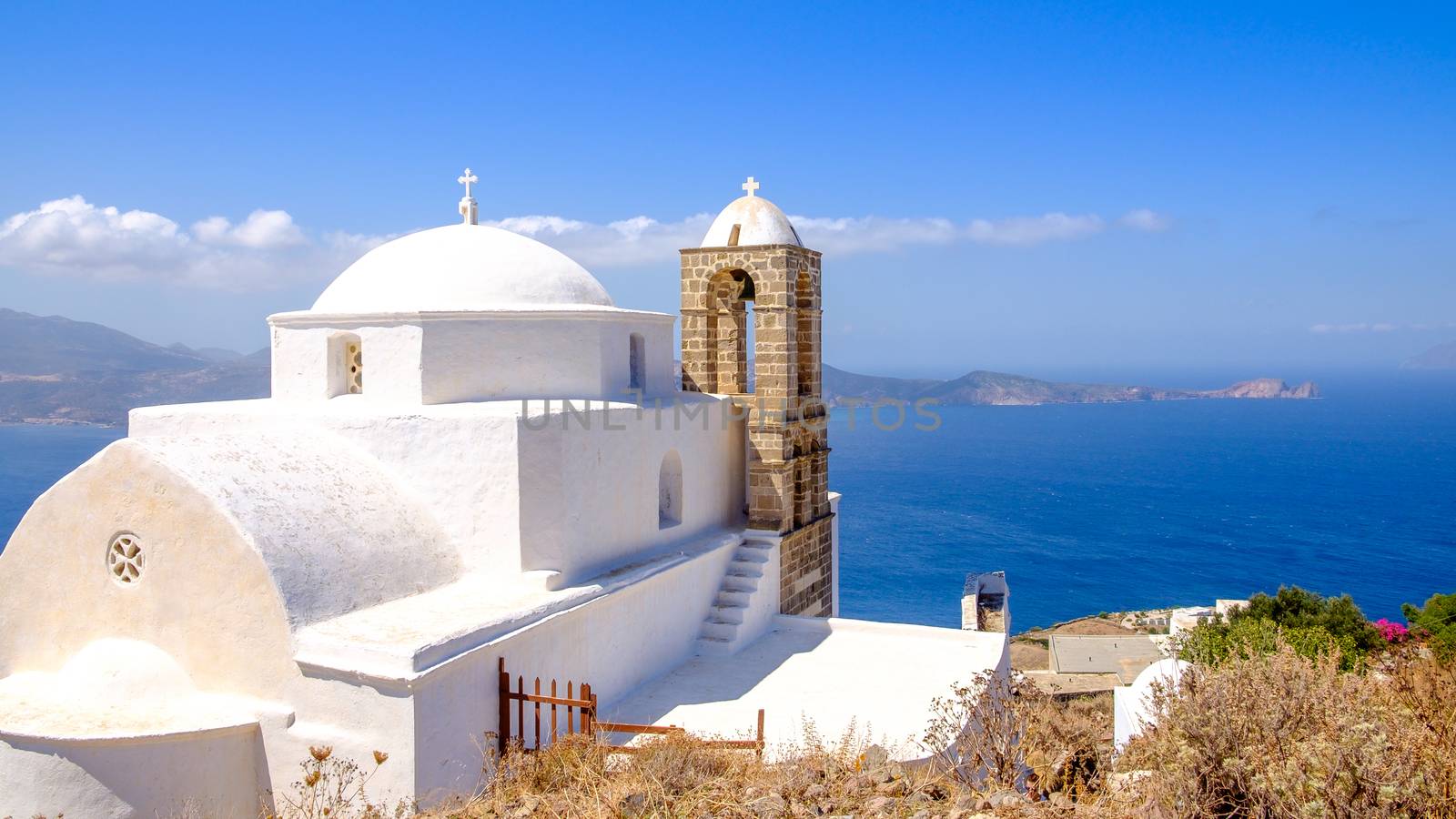 Panoramic view of traditional greek cycladic church and sea, Plaka, Milos island, Greece