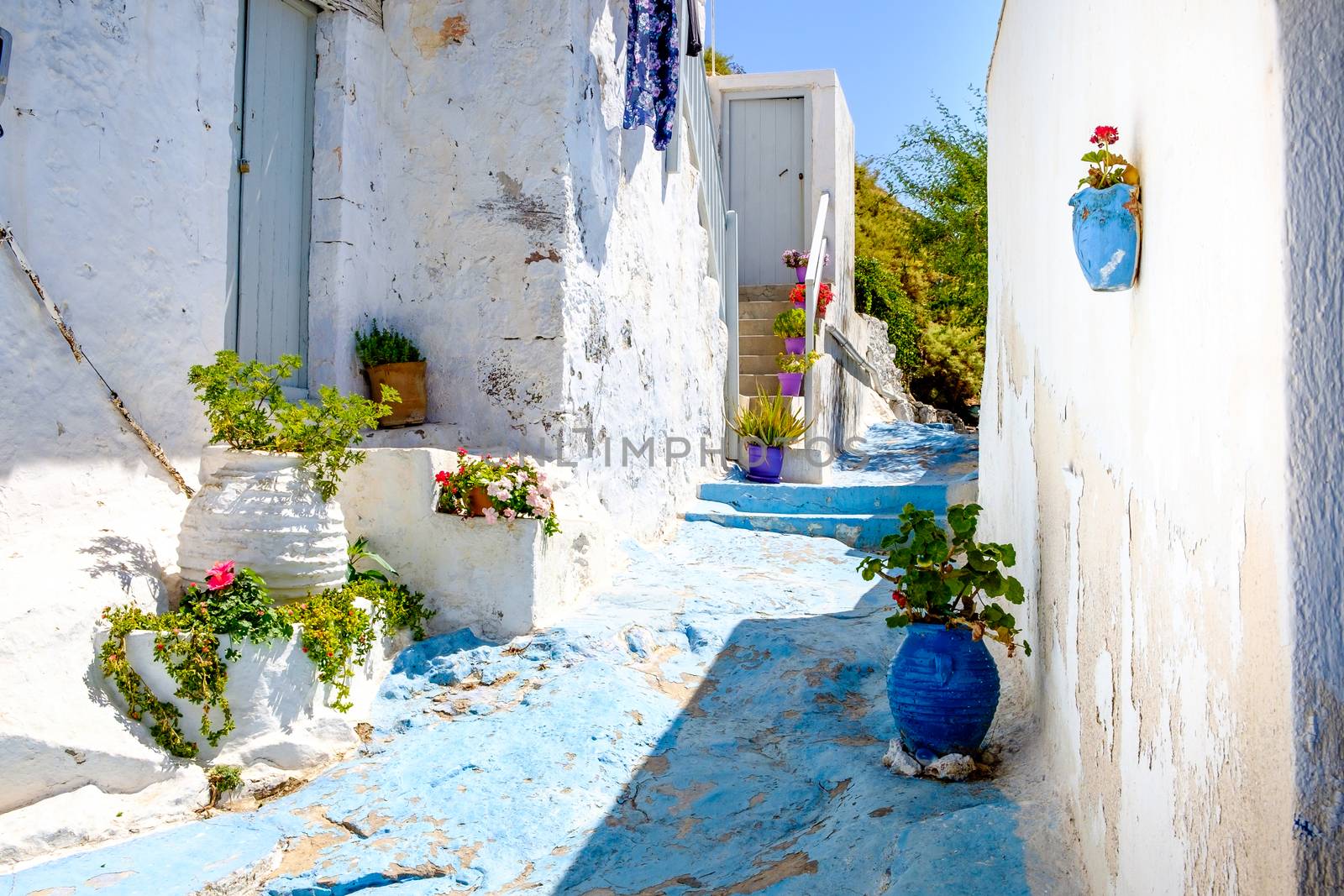 Beautiful street in old traditional Greek cycladic village Plaka by martinm303