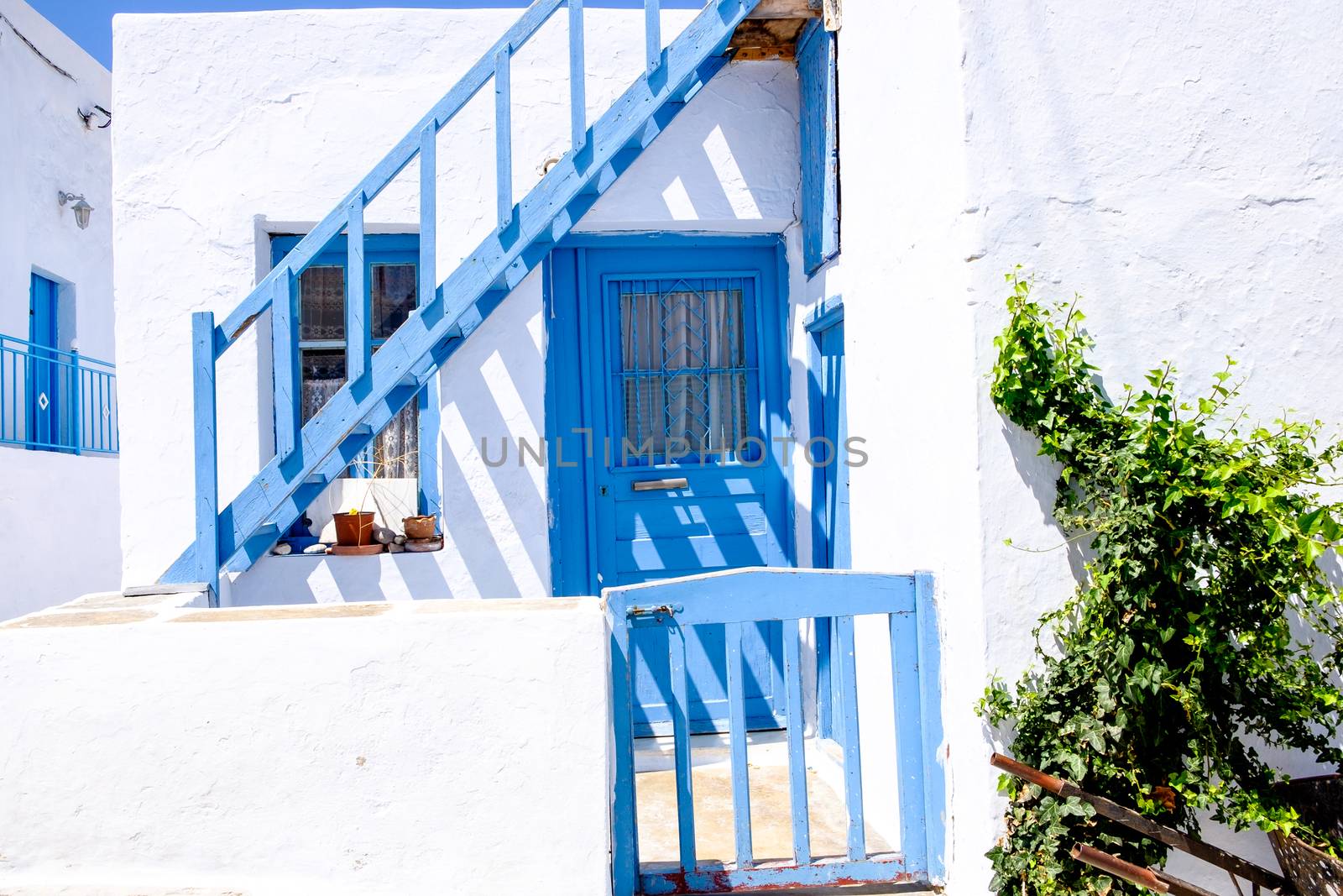 Typical traditional doors and windows in white and blue style, Plaka village on Milos island, Greece