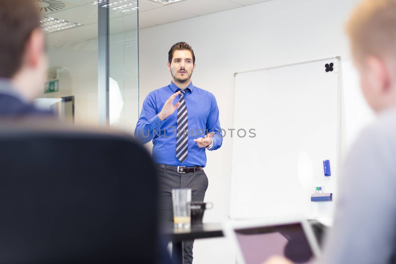 Workplace in modern office with business people brainstorming. Businessman working on laptop during the meeting.