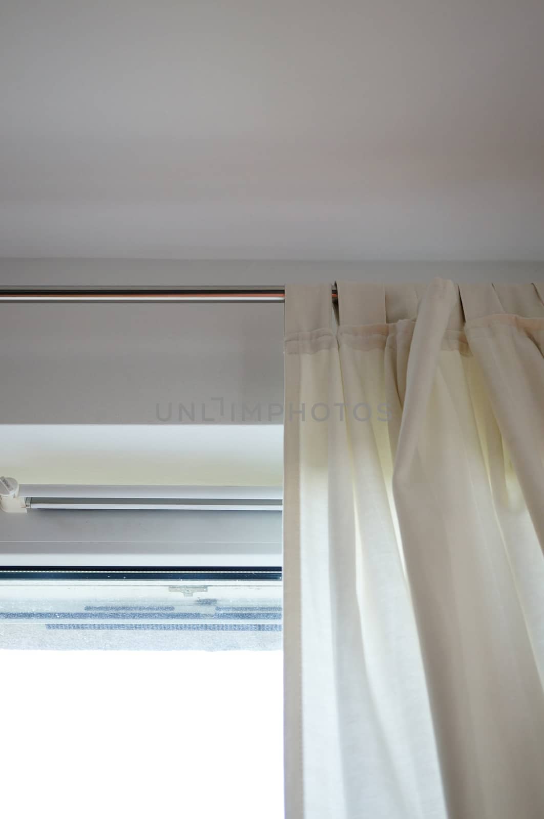 Light fabric curtains by an window