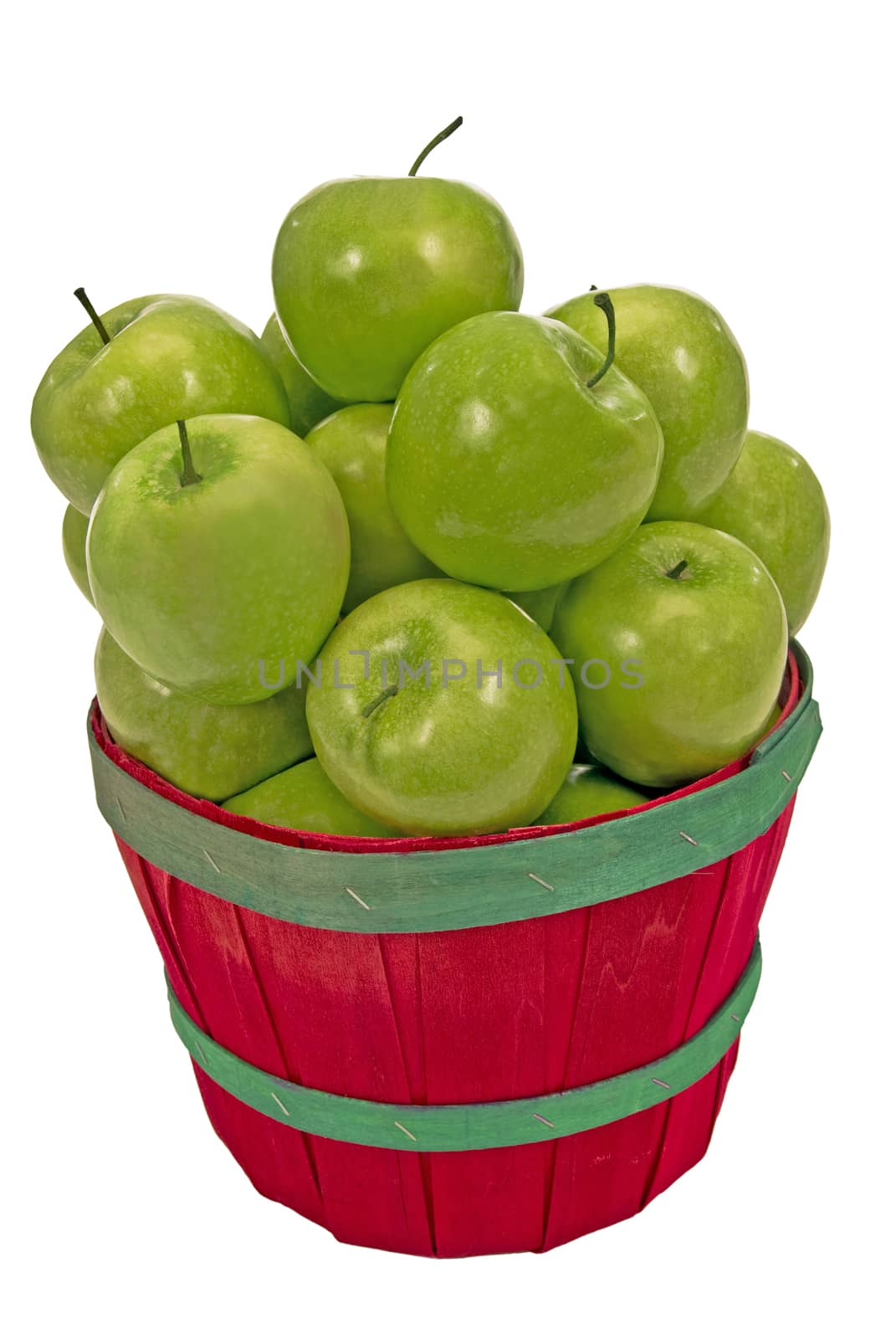 Close up shot of a small basket overloaded with fresh picked green apples on a white background.