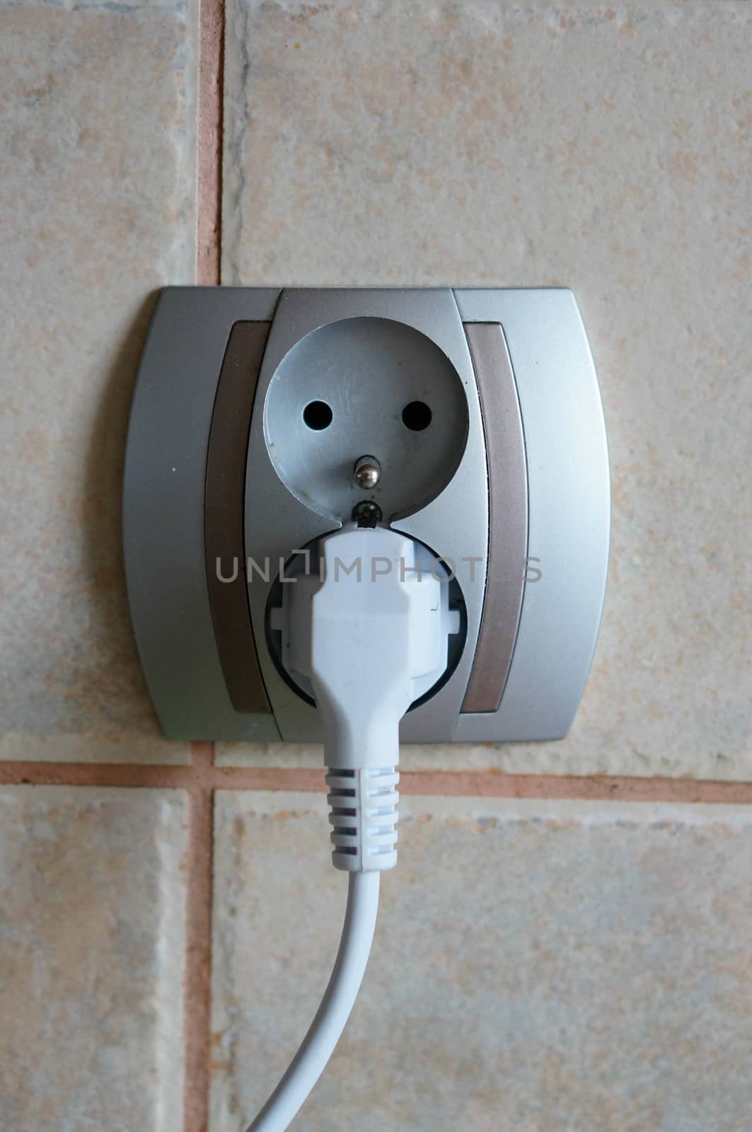 Plug in socket on tiles wall