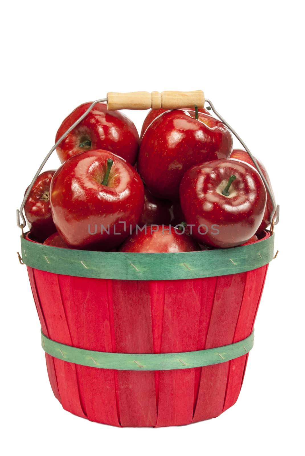 Vertical shot of a cute little red basket full of delicious red apples on a white background.