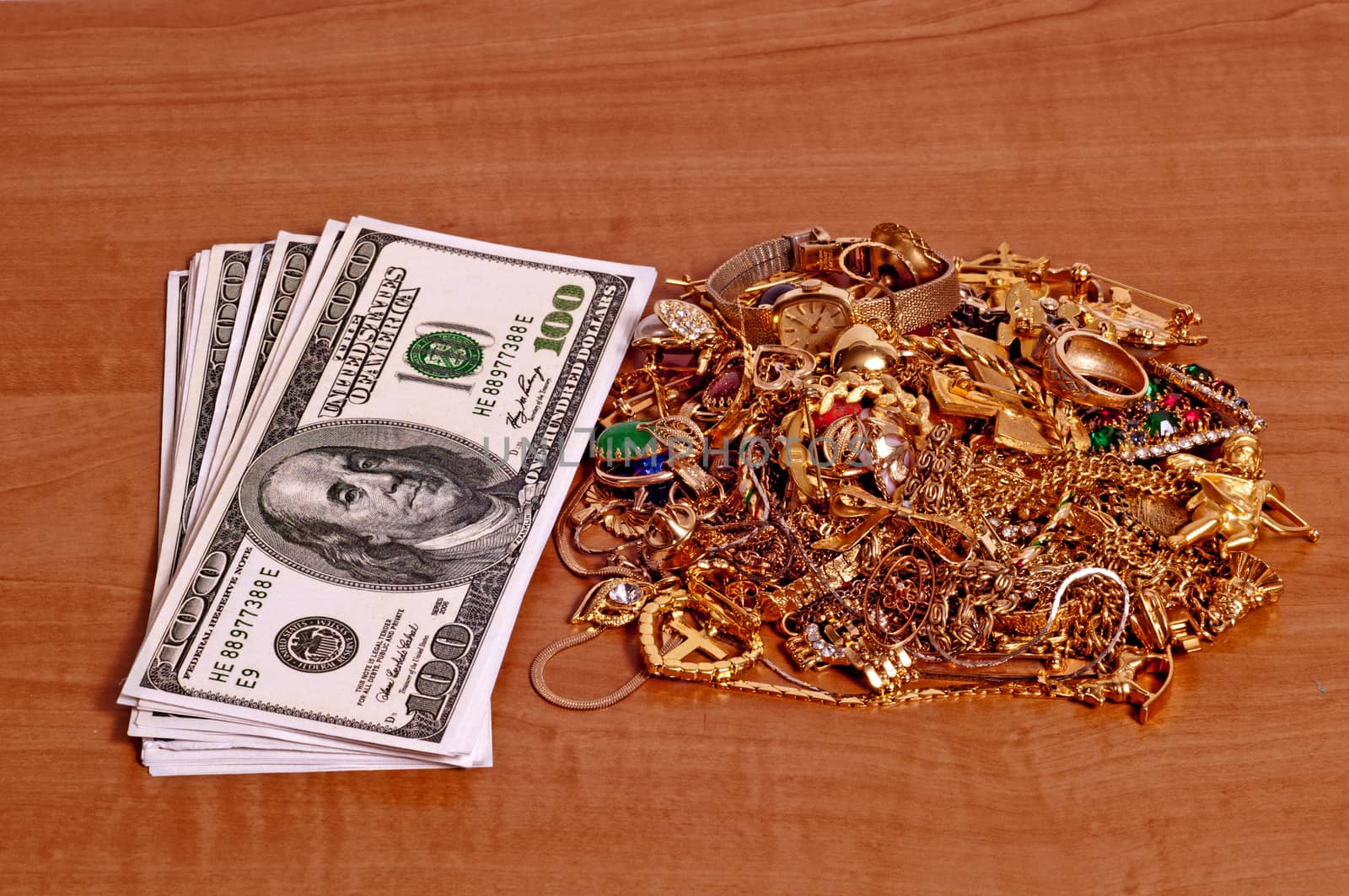 Money And Gold Jewelry On Wood Counter by stockbuster1