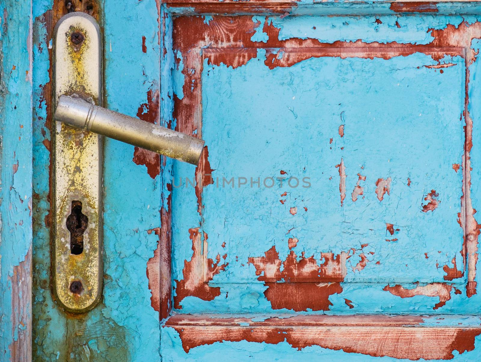 Detail of metal knob on old rusty textured wooden door by martinm303