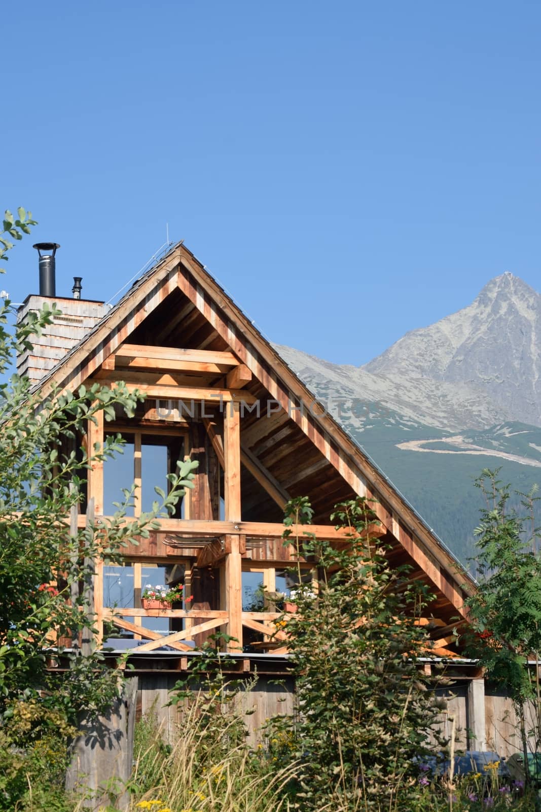 Wooden mountain cottage with mountains in background