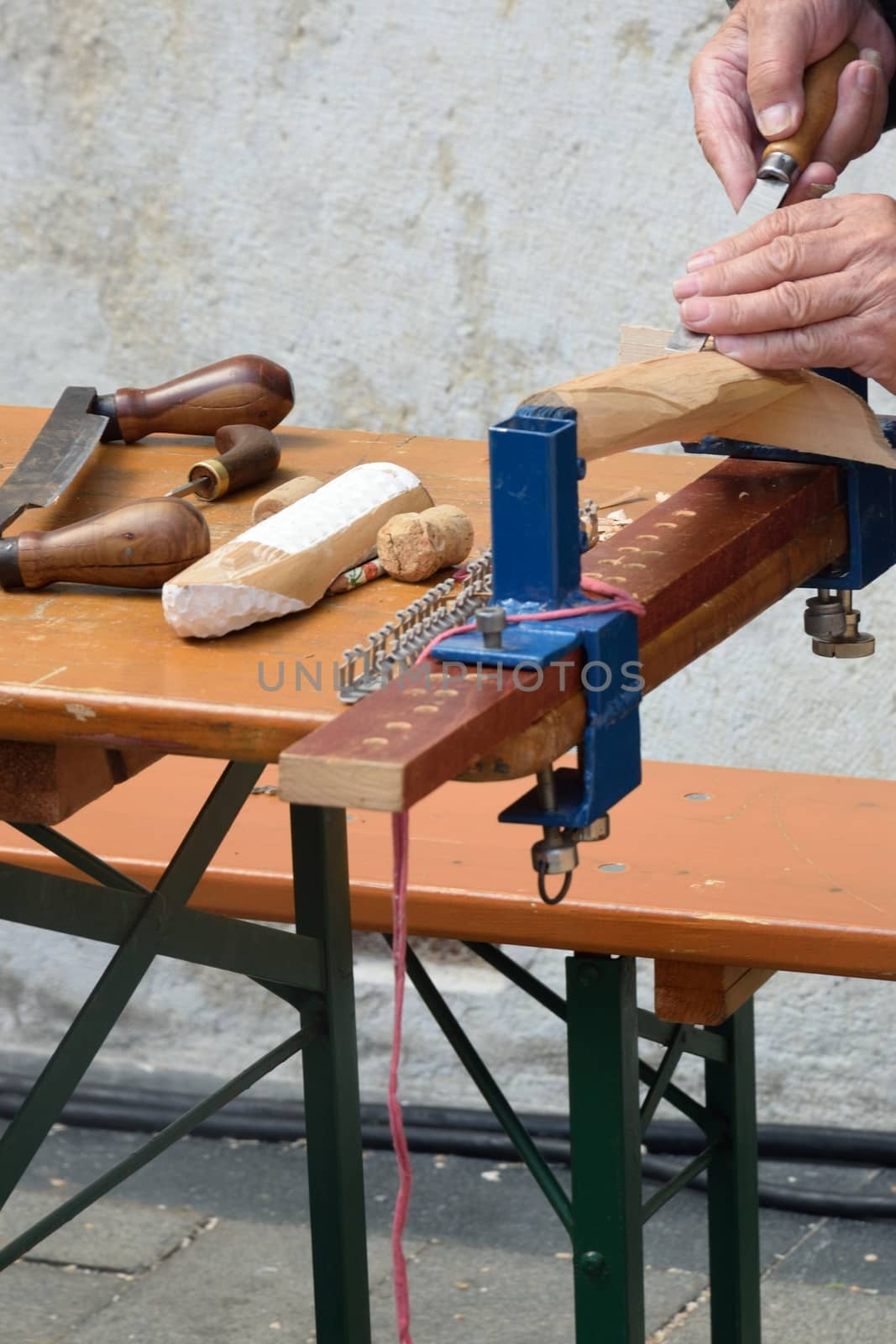 Man carving wood on bench by pauws99