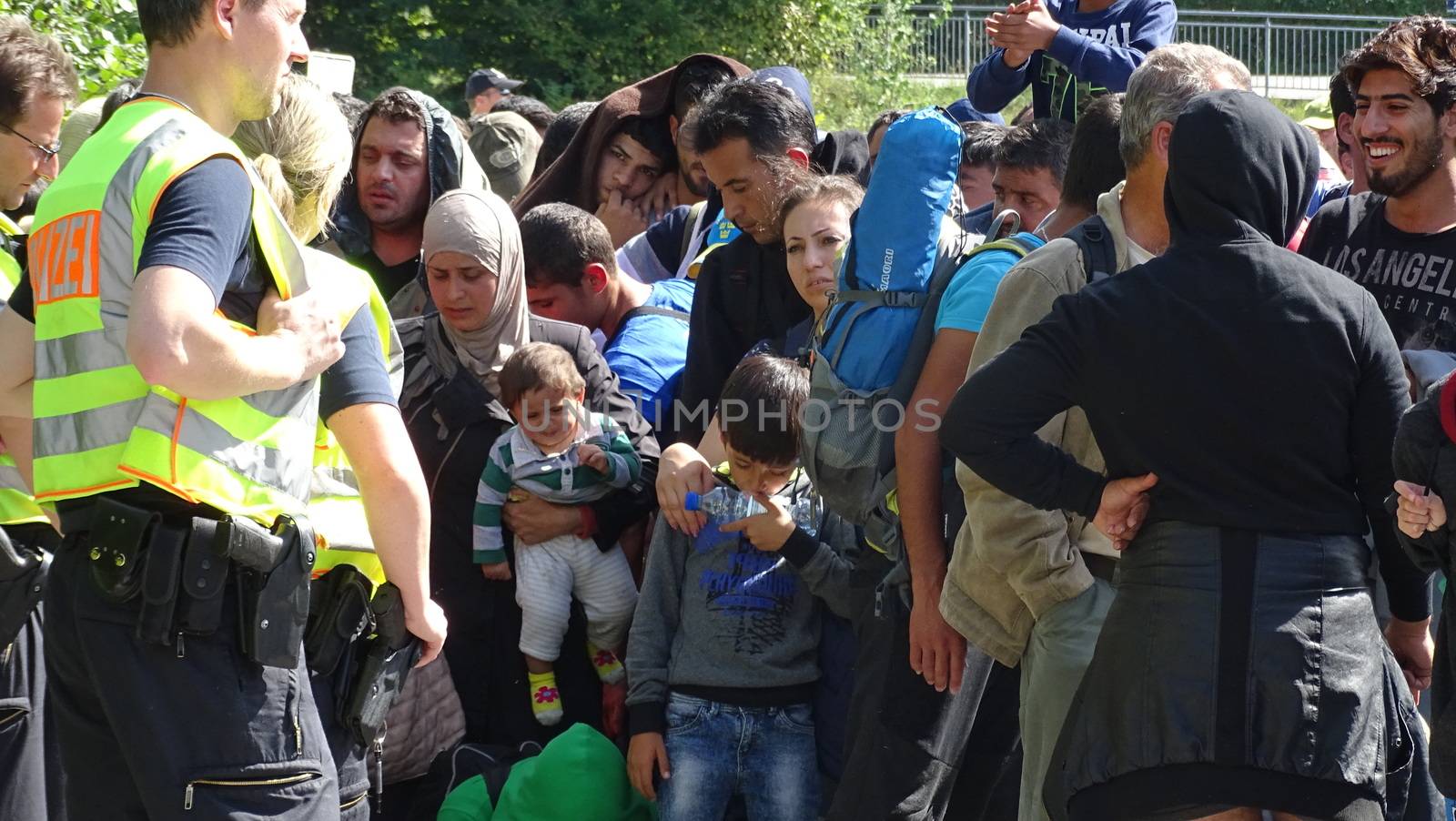 GERMANY, Freilassing: Refugees wait at the gates of Freilassing, Bavaria, on the German side of the Germany-Austria border, September 16, 2015.