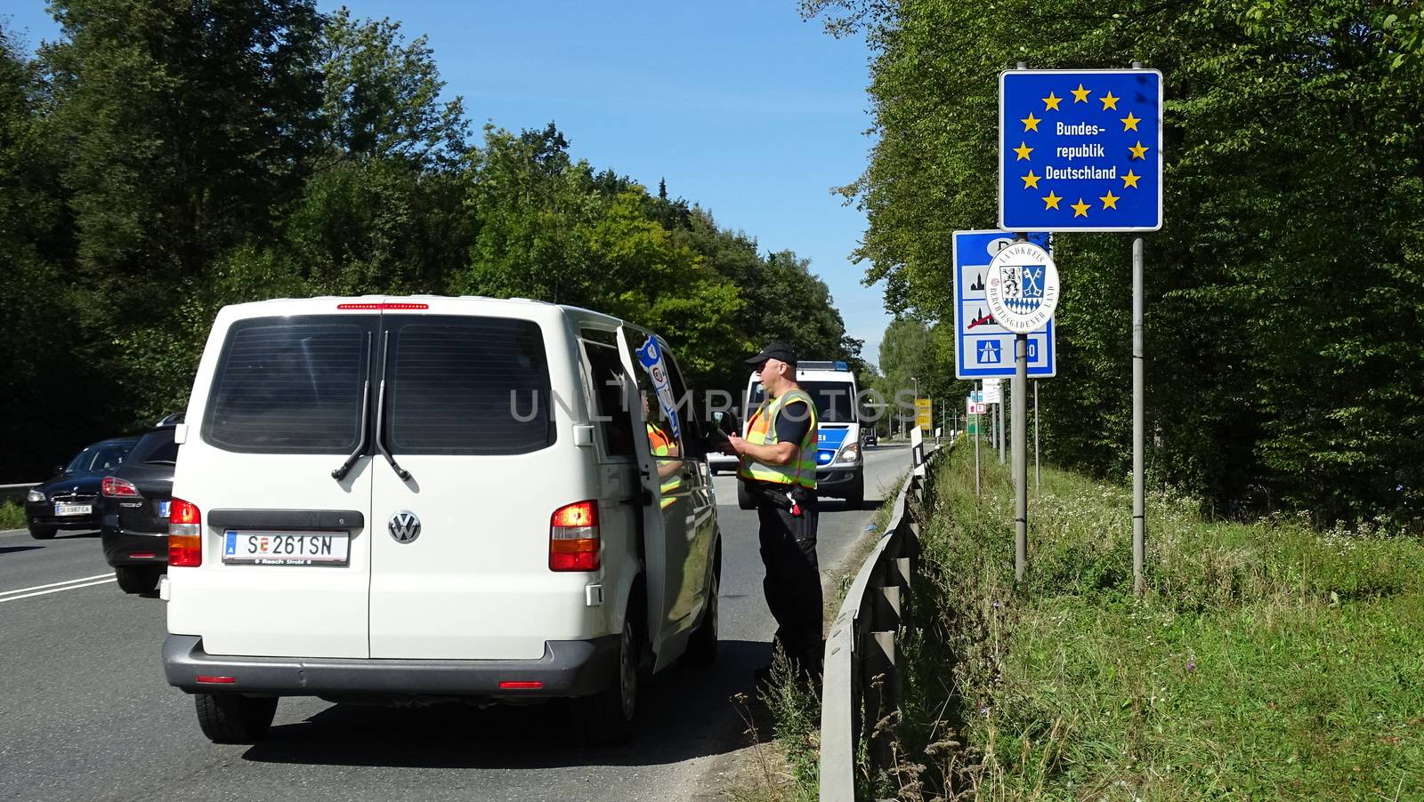 GERMANY, Freilassing: A German policeman speaks with a passenger of a car in Freilassing, Bavaria, on the German side of the Germany-Austria border, September 16, 2015.