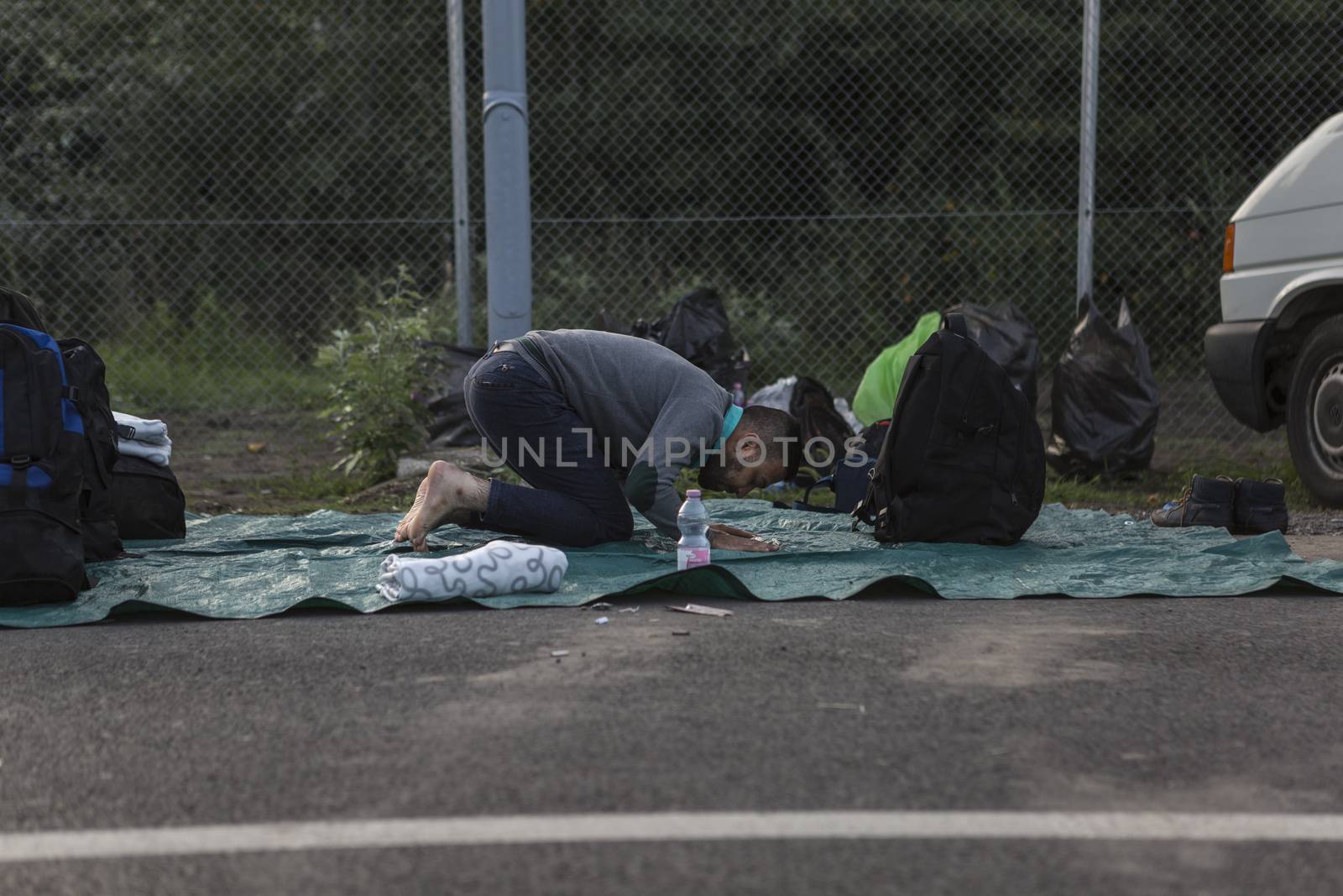 SERBIA, Horgos: A man prays at the Serbia-Hungary border after Hungary closed the border crossing on September 16, 2015.****Restriction: Photo is not to be sold in Russia or Asia****