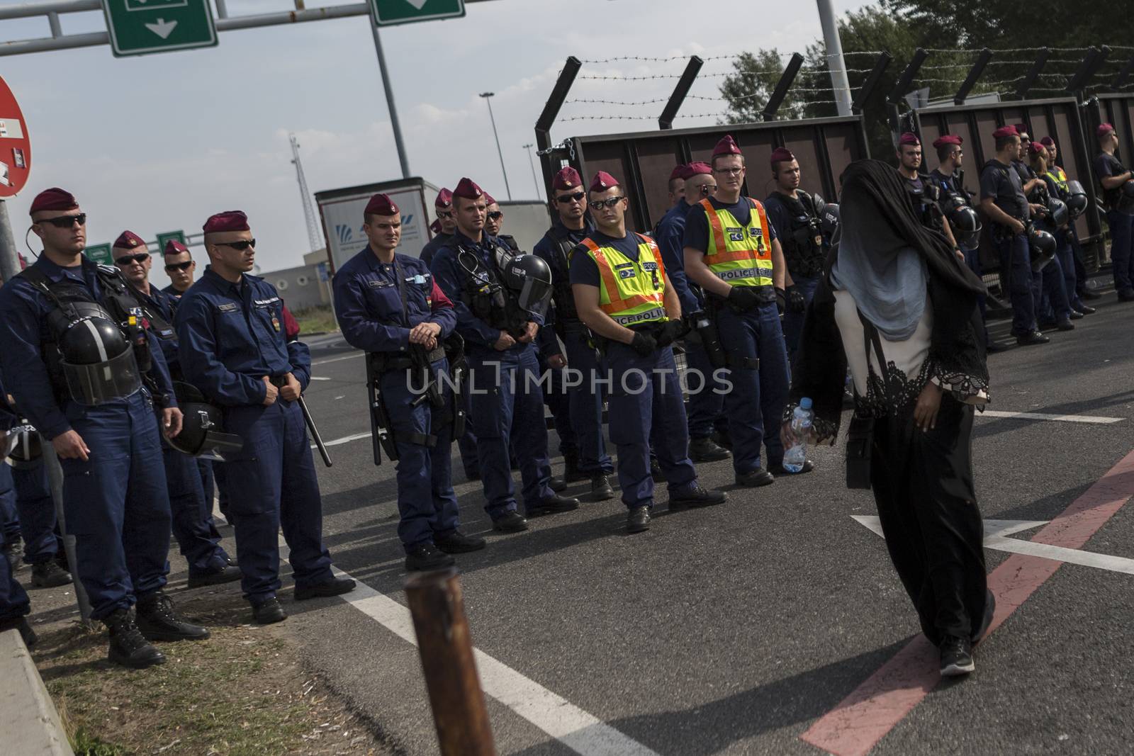 SERBIA, Horgos: A woman approaches Hungarian border guards at the Serbia-Hungary border after Hungary closed the border crossing on September 16, 2015.****Restriction: Photo is not to be sold in Russia or Asia****