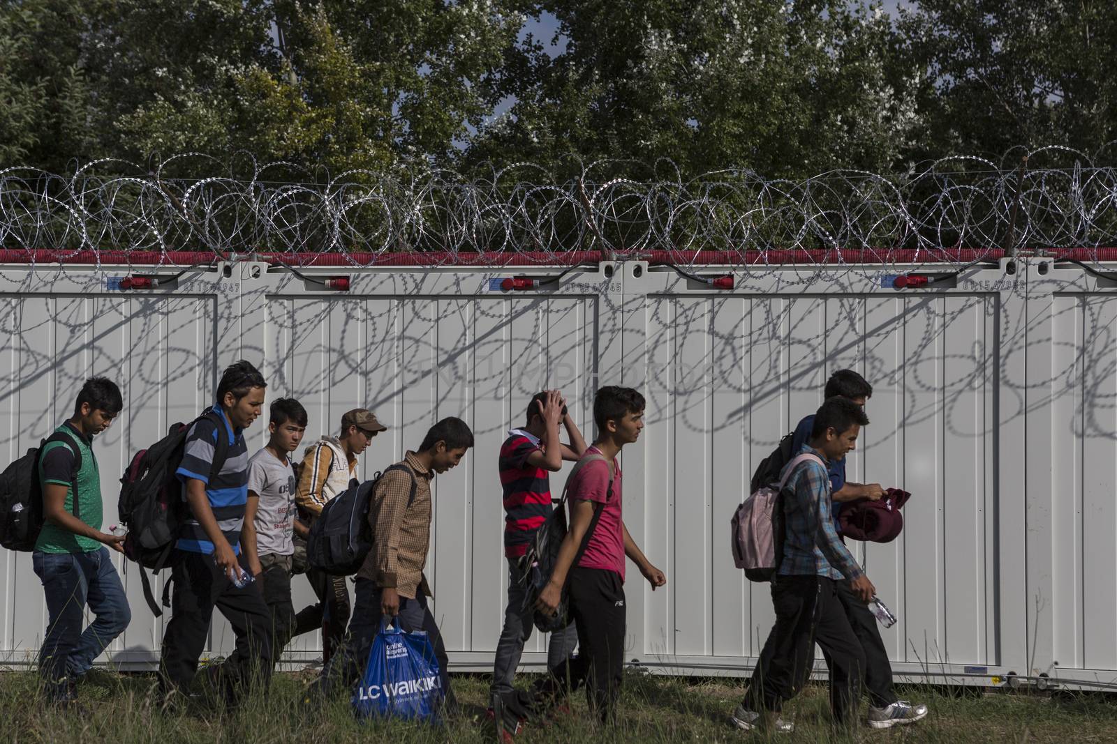 SERBIA, Horgos: Refugees walk along the Serbia-Hungary border after Hungary closed the border crossing on September 16, 2015.****Restriction: Photo is not to be sold in Russia or Asia****