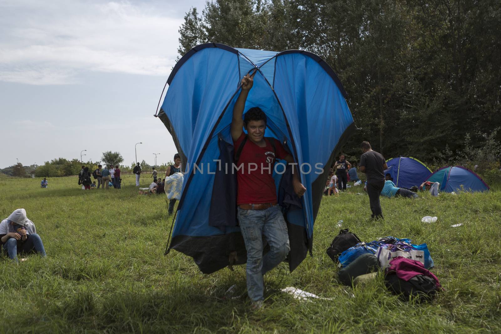 SERBIA, Horgos: A refugee carries a tent at the Serbia-Hungary border, after Hungary closed the border crossing on September 16, 2015.****Restriction: Photo is not to be sold in Russia or Asia**** Refugee carries a tent 