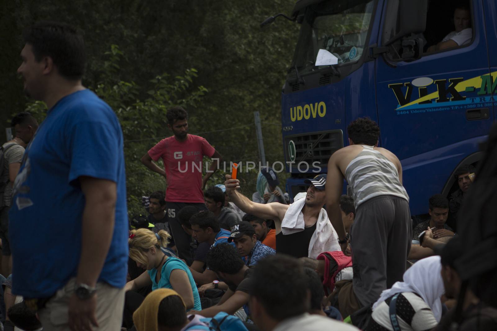 SERBIA, Horgos: A refugee takes a photo of himself as he and other refugees wait at the Serbia-Hungary border, blocking traffic, after Hungary closed the border crossing on September 16, 2015.****Restriction: Photo is not to be sold in Russia or Asia****