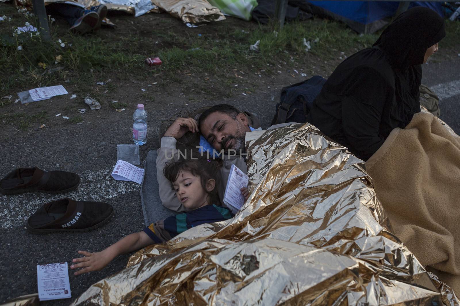 SERBIA, Horgos: Refugees lie and wait at the Serbia-Hungary border, blocking traffic, after Hungary closed the border crossing on September 16, 2015.****Restriction: Photo is not to be sold in Russia or Asia****