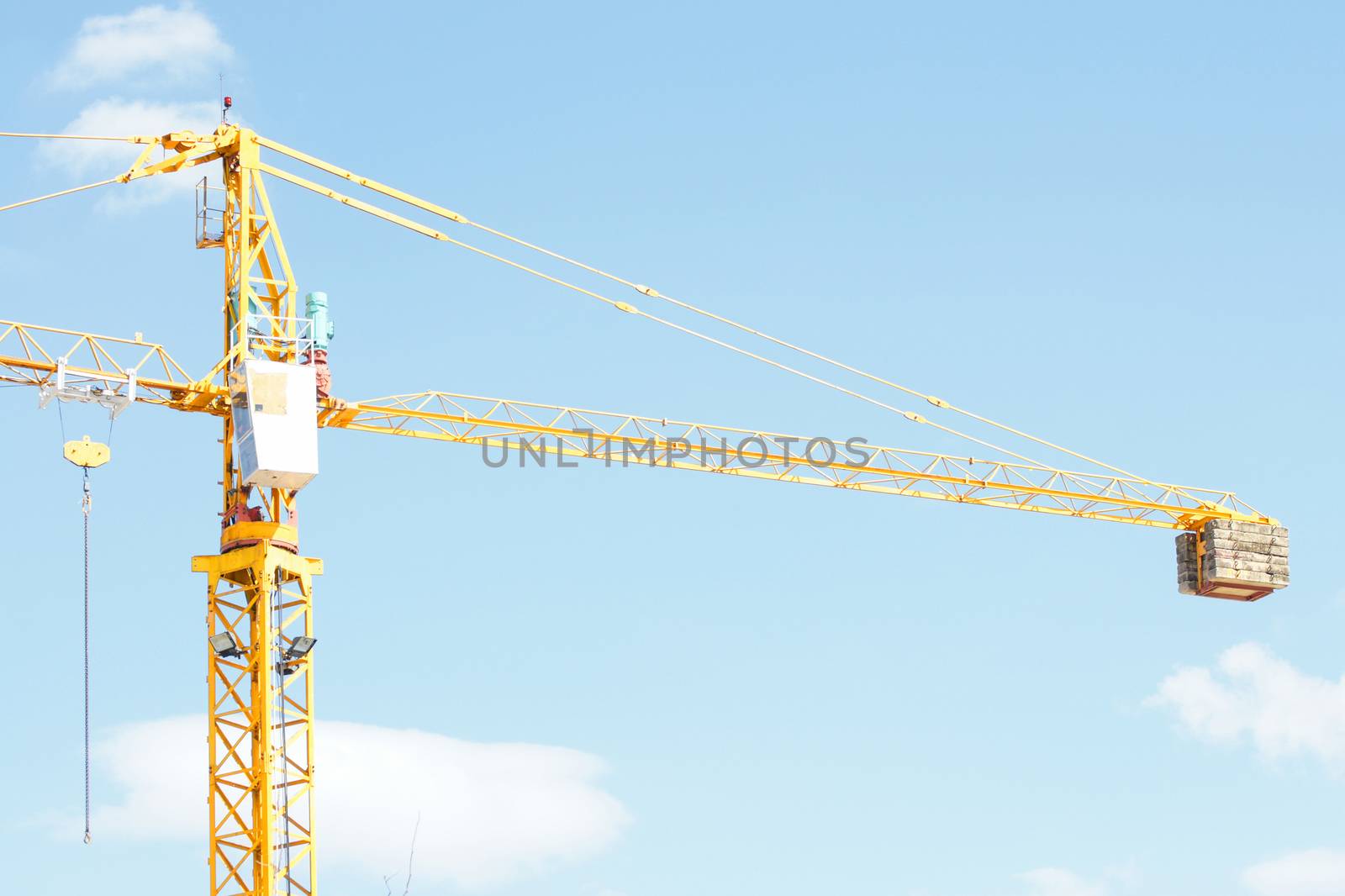 Yellow Industrial crane and blue sky on construction site or seaport