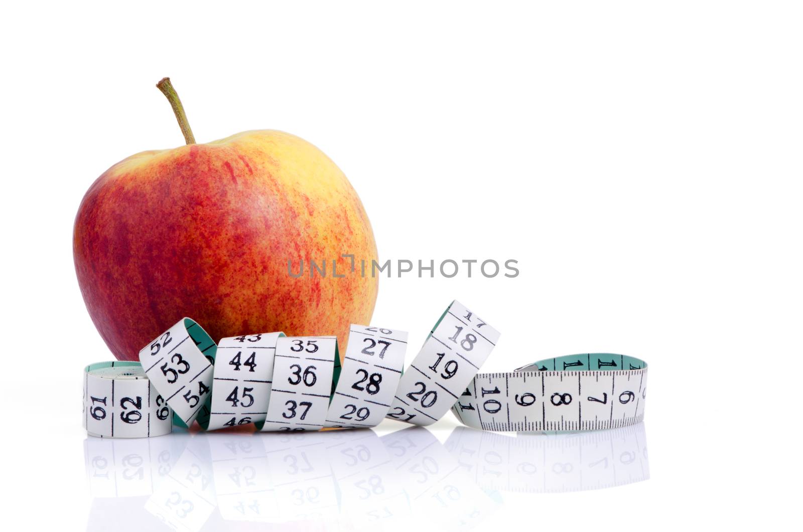 Red yellow apple with measure tape isolated on white background.