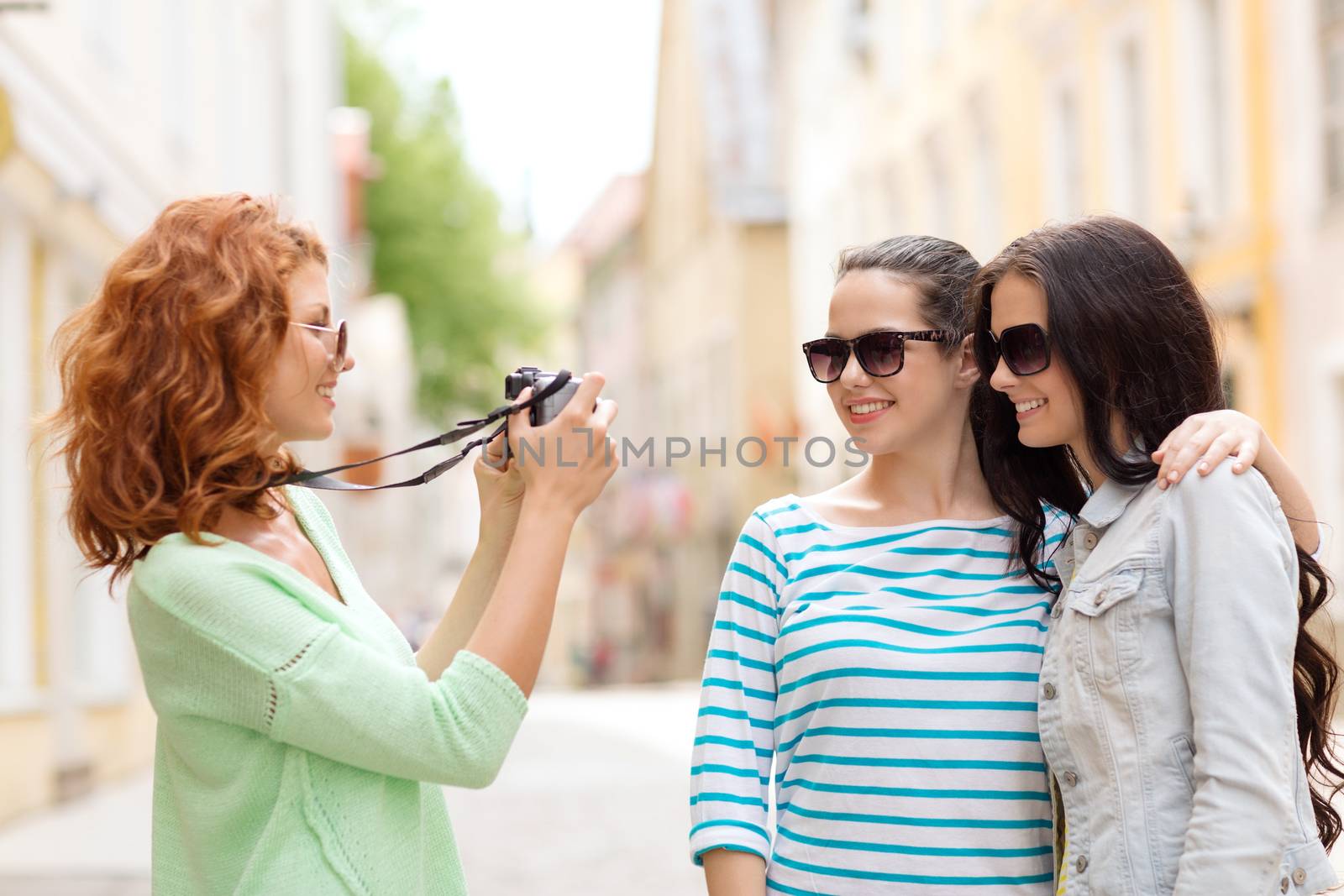 smiling teenage girls with camera by dolgachov