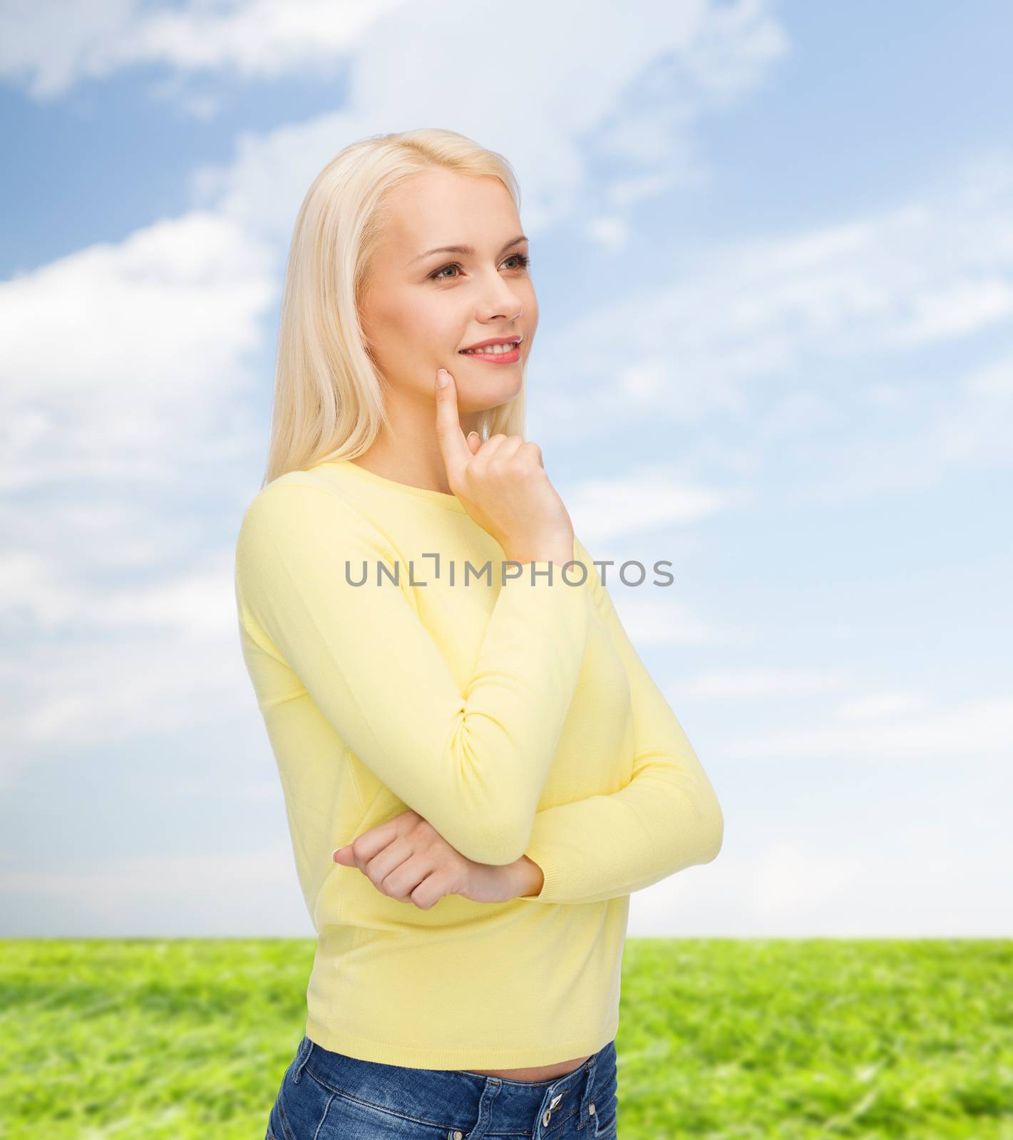 happiness and people concept - happy smiling young woman dreaming