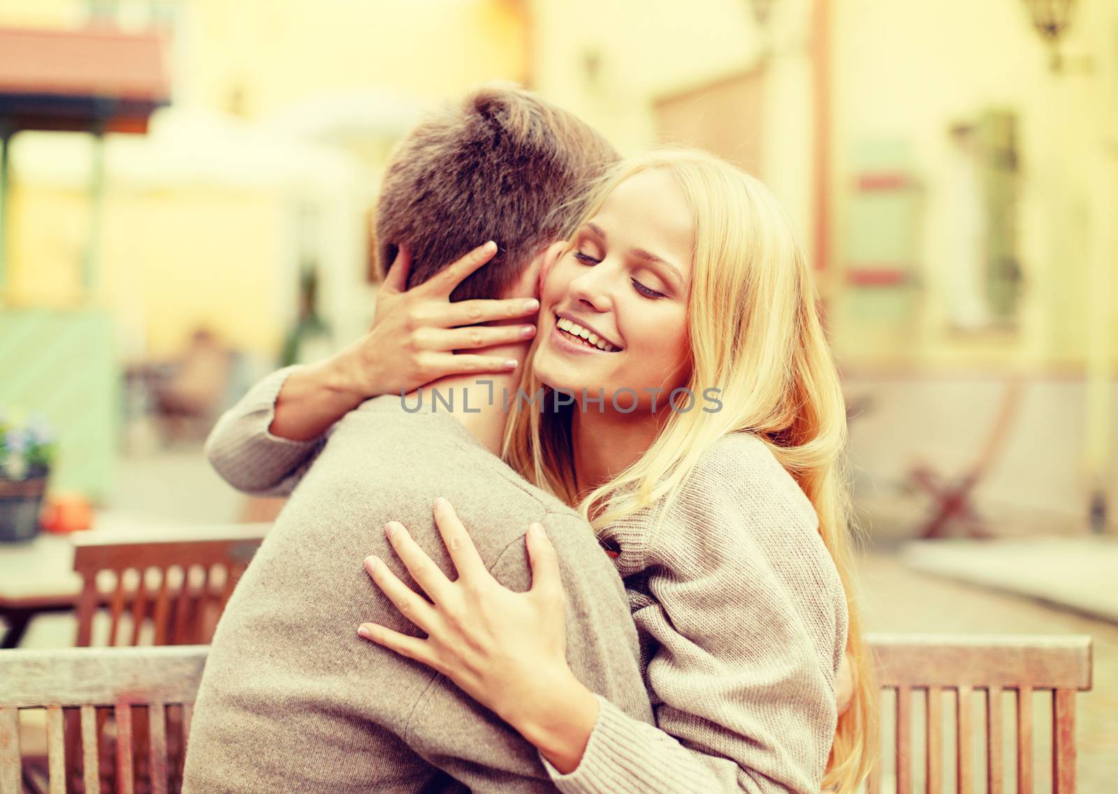 summer holidays, love, travel, relationship and dating concept - romantic happy couple hugging in the cafe