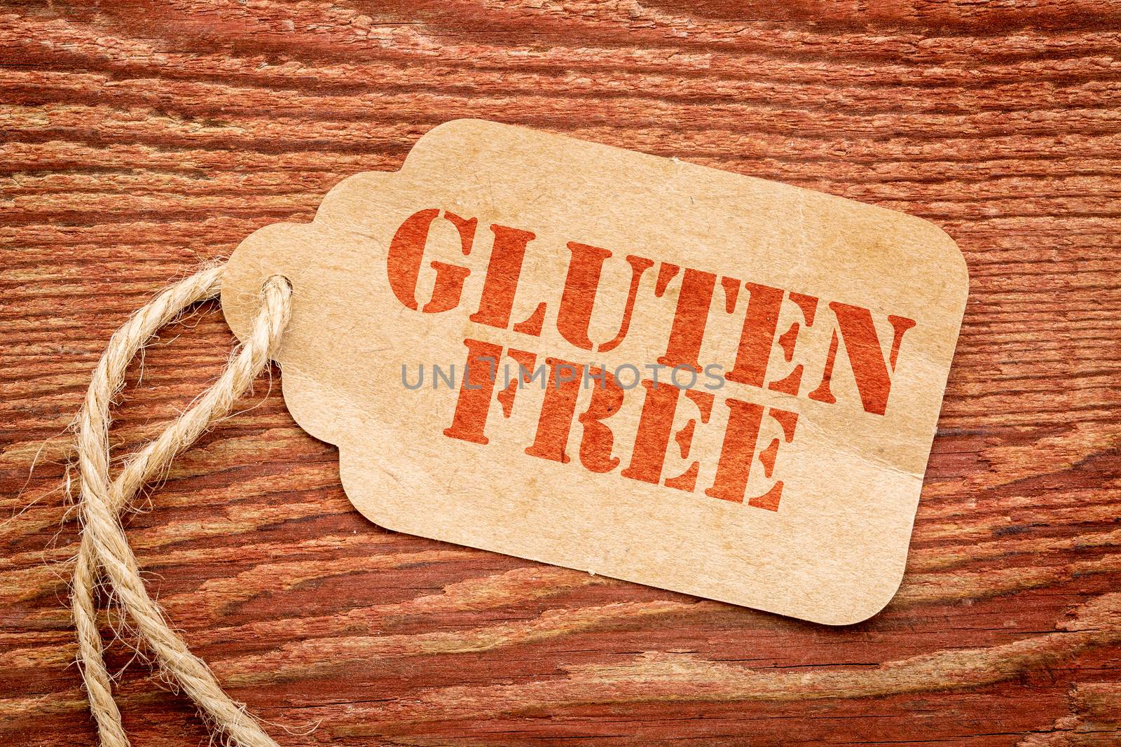 gluten free sign a paper price tag against rustic red painted barn wood