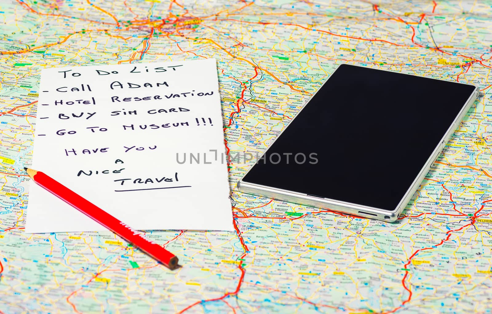 In the pictured a map, a pencil , a phone / tablet and a list of things to do .