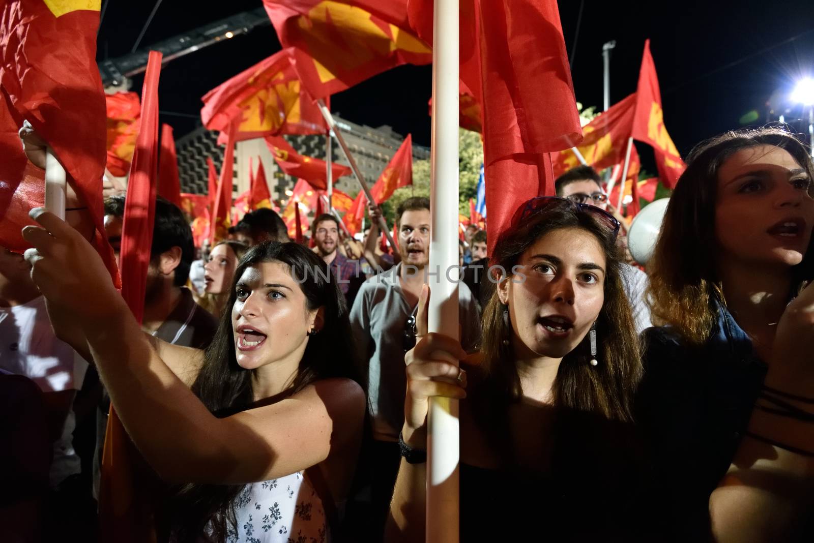 GREECE, Athens: Supporters of the Communist Party of Greece (KKE) cheer during the party's campaign rally in Athens on September 16, 2015, ahead of the forthcoming snap elections on September 20. At the rally, KKE General Secretary Dimitris Koutsoumpas addressed supporters.