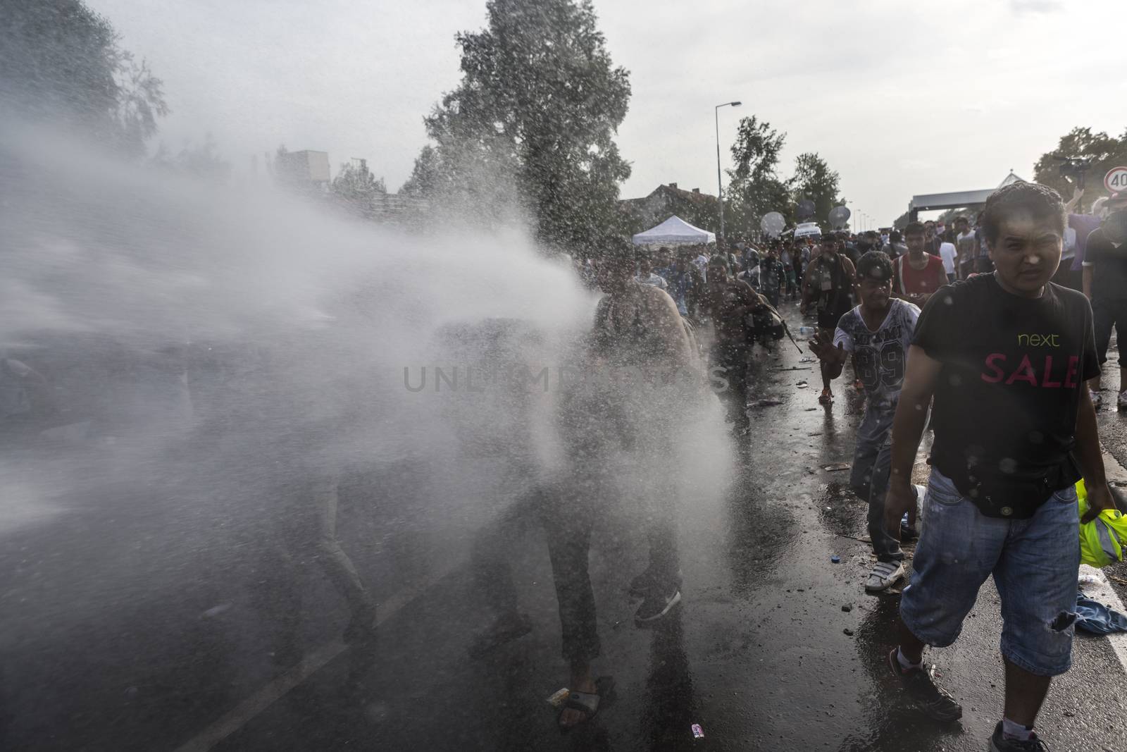 SERBIA, Horgos: Hungarian police fire tear gas and water cannons into the refugees in the Serbian border town of Horgos on September 16, 2015, after Hungary closed its border in an effort to stem the wave of refugees entering the country. 