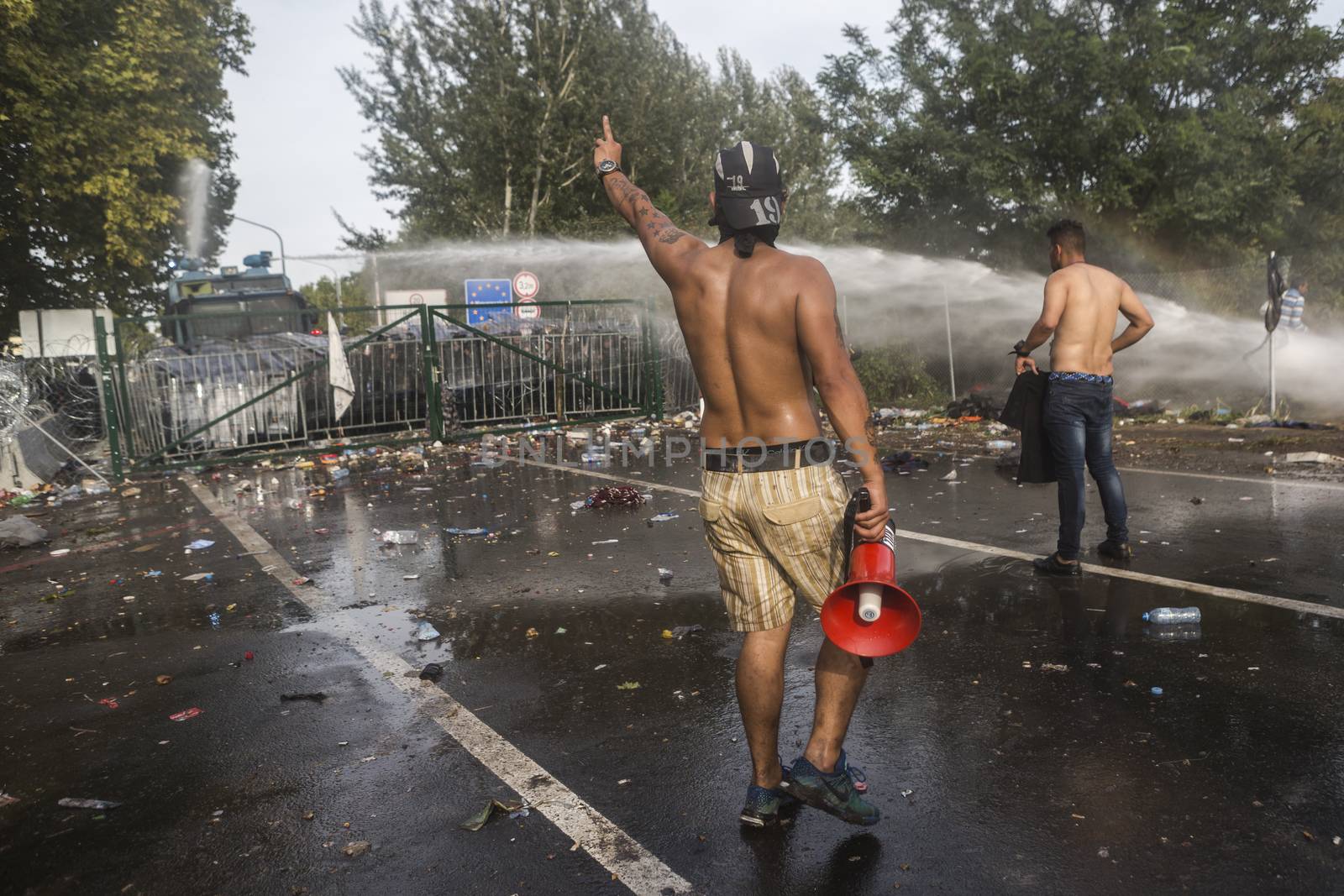 SERBIA, Horgos: Hungarian police fire tear gas and water cannons into the refugees in the Serbian border town of Horgos on September 16, 2015, after Hungary closed its border in an effort to stem the wave of refugees entering the country. 