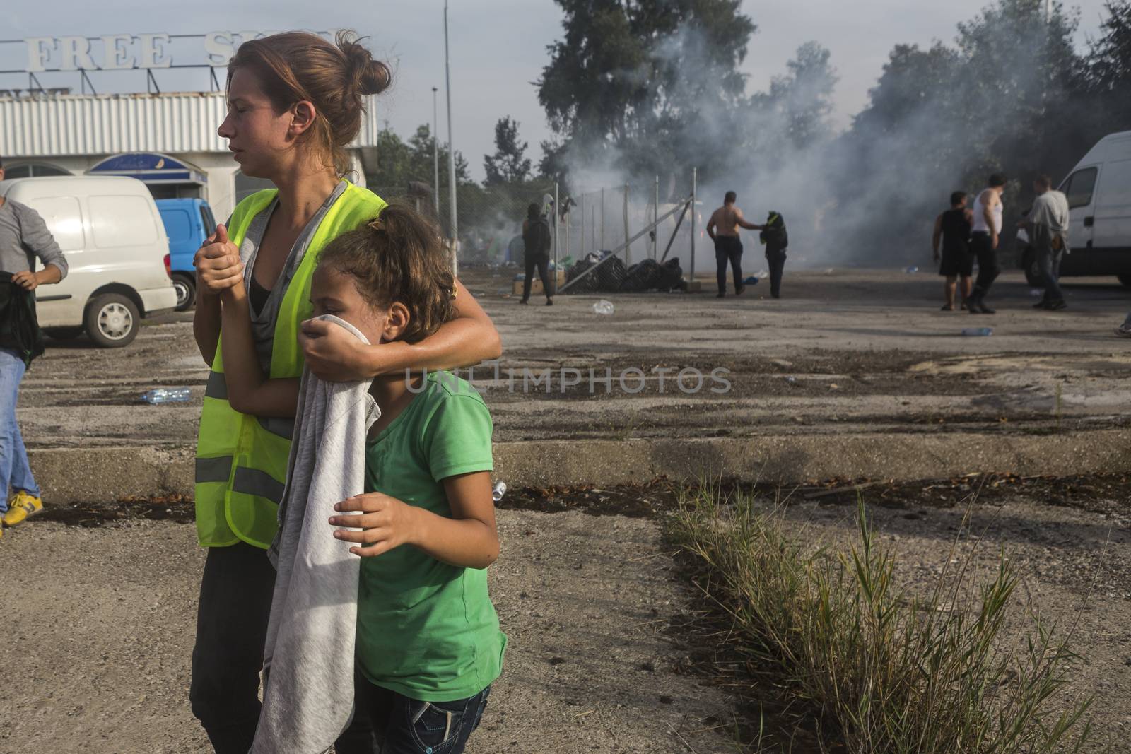 SERBIA, Horgos: A child's face is covered as Hungarian police fire tear gas and water cannons into the refugees in the Serbian border town of Horgos on September 16, 2015, after Hungary closed its border in an effort to stem the wave of refugees entering the country. 