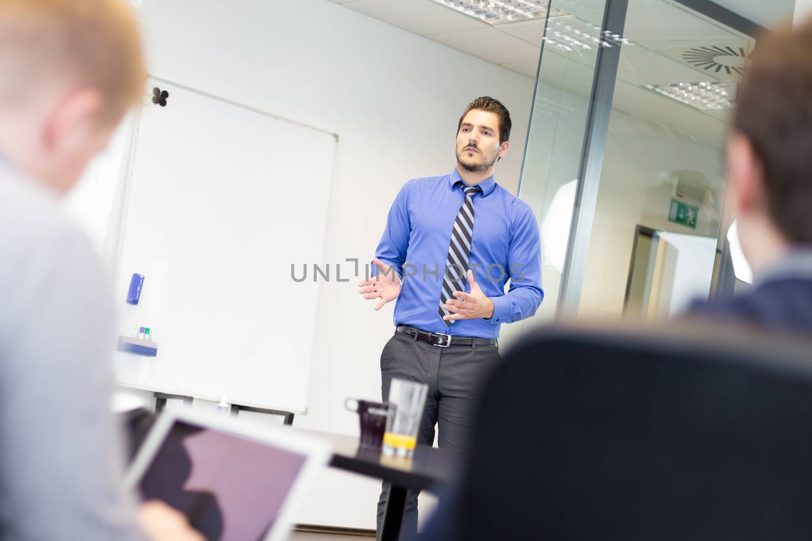 Workplace in modern office with business people brainstorming. Businessman working on laptop during the meeting.