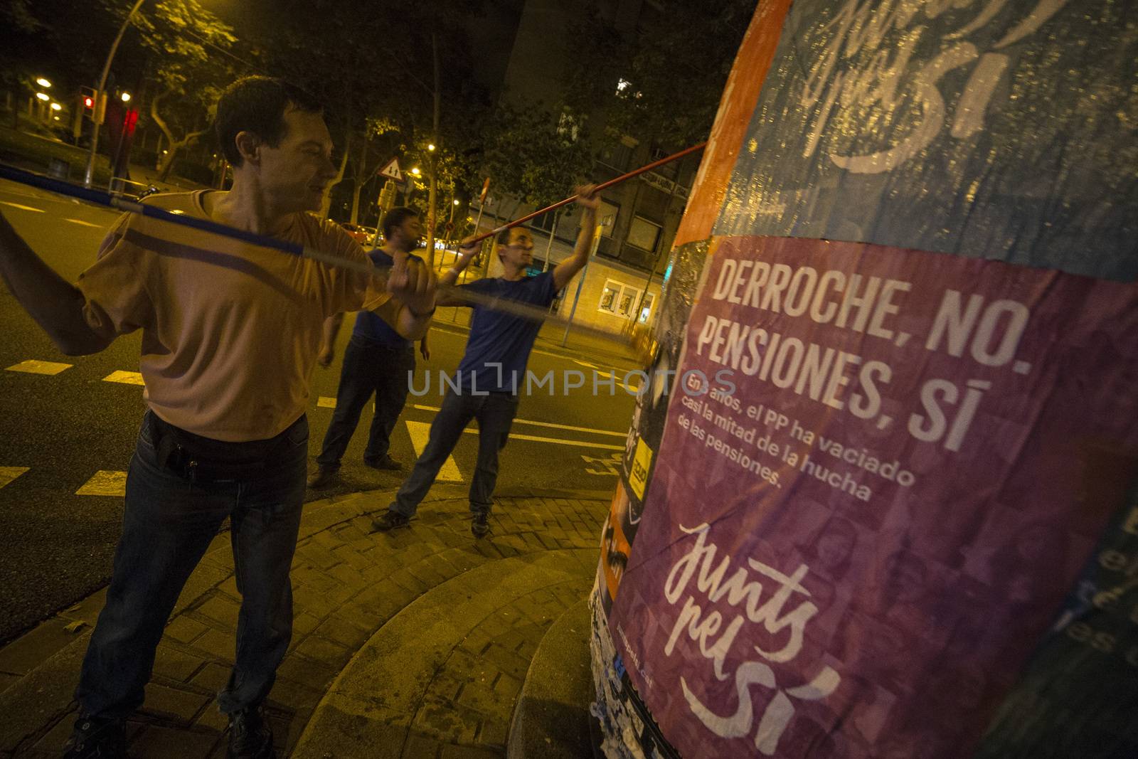 SPAIN, Barcelona: Activists from the pro-independence coalition Junts pel Si (Together for Yes) stick up posters around Barcelona on the evening of September 16, 2015. Pro-independence groups are rallying their supporters ahead of the Catalonian parliamentary election, taking place on September 27.