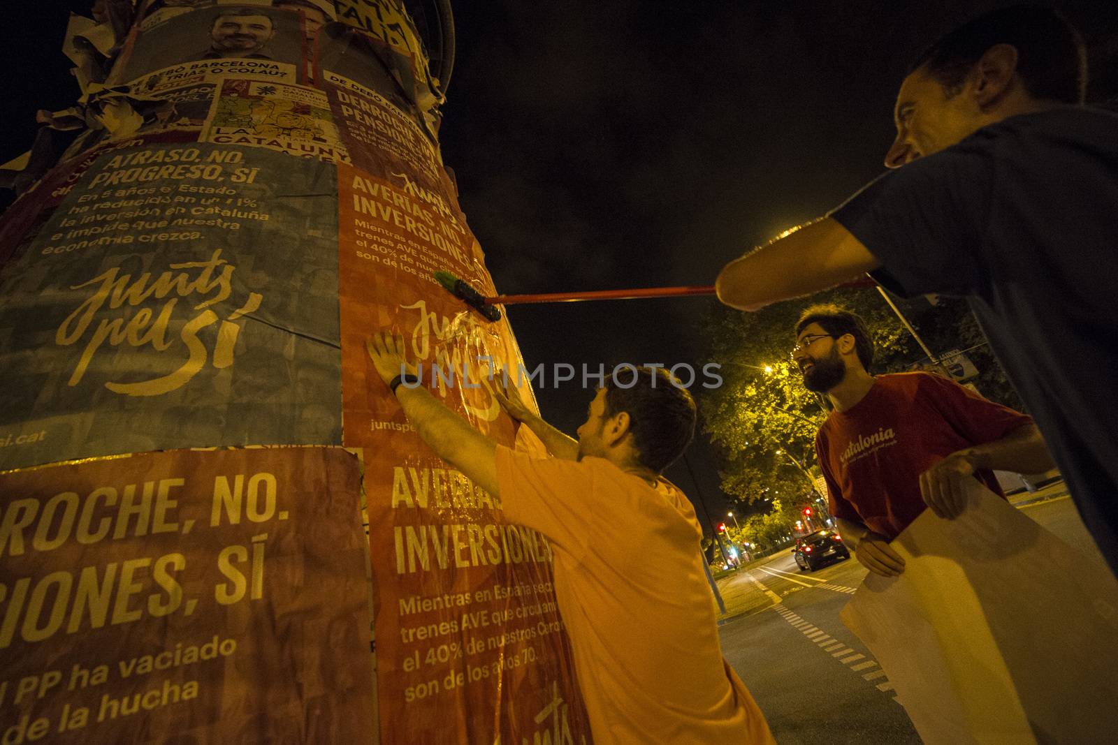 SPAIN, Barcelona: Activists from the pro-independence coalition Junts pel Si (Together for Yes) stick up posters around Barcelona on the evening of September 16, 2015. Pro-independence groups are rallying their supporters ahead of the Catalonian parliamentary election, taking place on September 27.