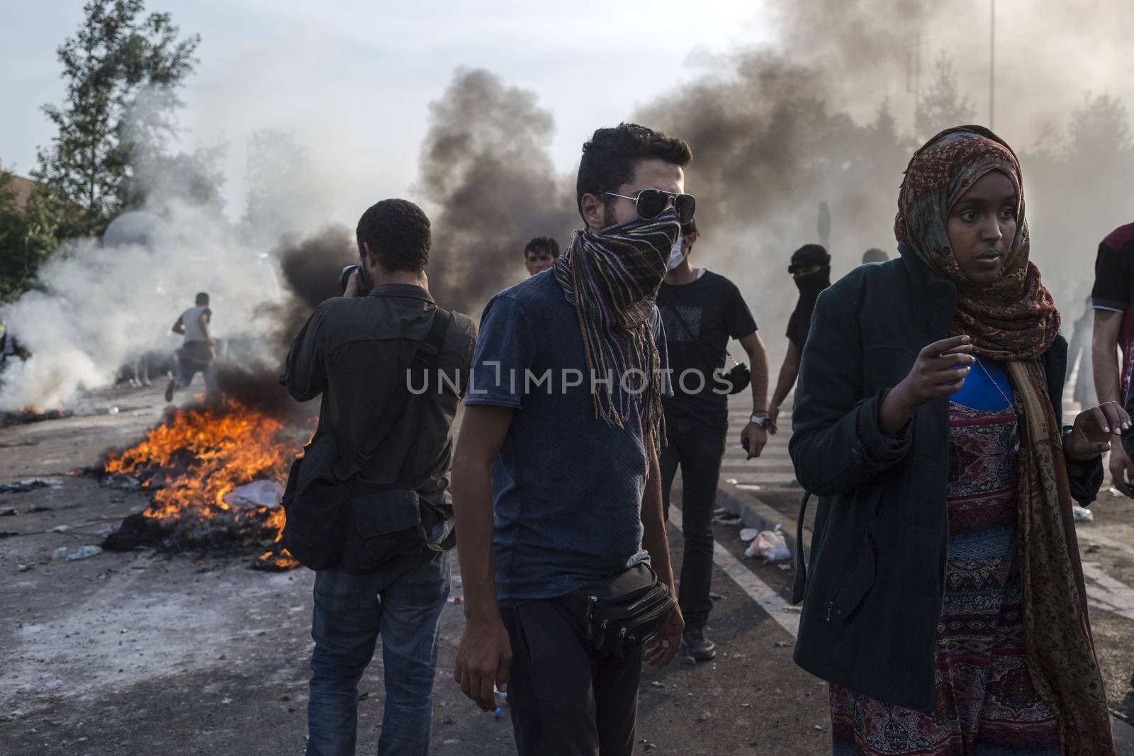 SERBIA, Horgos: Fires rage as Hungarian police fire tear gas and water cannons into the refugees in the Serbian border town of Horgos on September 16, 2015, after Hungary closed its border in an effort to stem the wave of refugees entering the country. ****Restriction: No Russia or Asia sales****