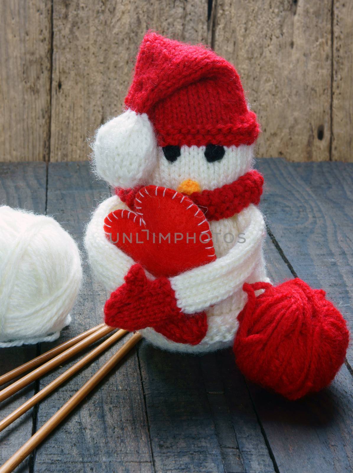 Knitted Xmas ornament, handmade snowman, hand made penguin knit from red, white wool, this toy for christmas holiday, abstract background with pine cone, gift card, red heart