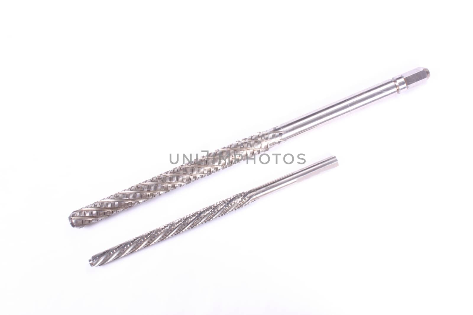 A pair of well designed industrial broaches used in automobile machinery, on white studio background.